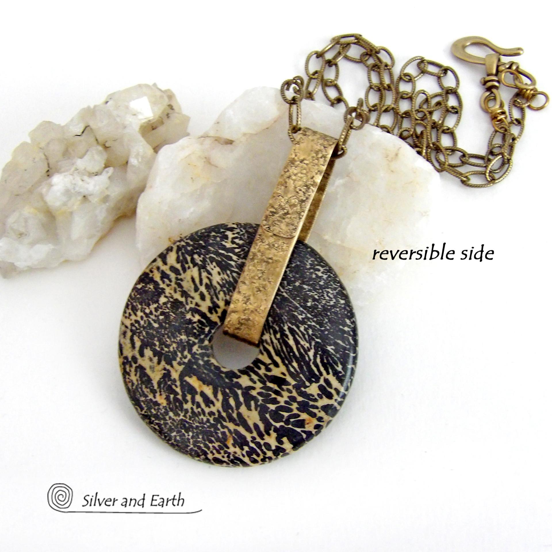 This one-of-a-kind pendant necklace features a stunning artistic jasper stone accented with a hand forged gold brass bail. This type of jasper is known for its intricate, natural patterns that resemble brushstrokes, landscapes, or abstract art. The stone in this piece has a natural bold dramatic pattern in hues of black and soft golden yellow with black streaks that resemble "feathery" dendrites. The design is modern and bold - yet classic and always in fashion. It can be worn by either a man or women. 