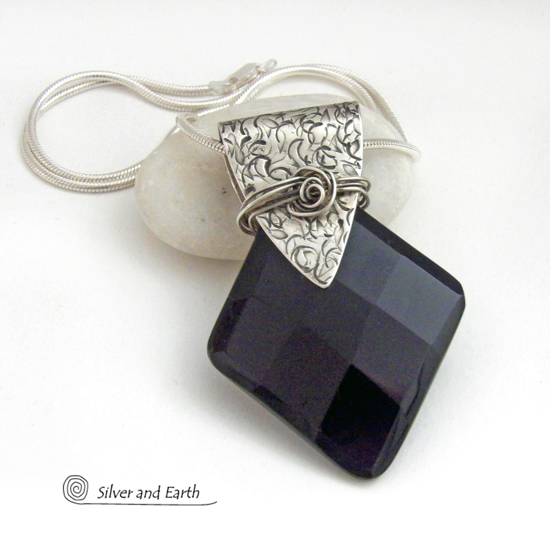 This handcrafted sterling silver necklace features a large, faceted black onyx gemstone accented with a handcrafted sterling bail. Perfect for any occasion – it will look great dressed up or down. The stone has been carved into a diamond shape and has a multi-faceted finish which casts off a natural sparkle and shine. Handmade in the USA by Silver and Earth Jewelry.
