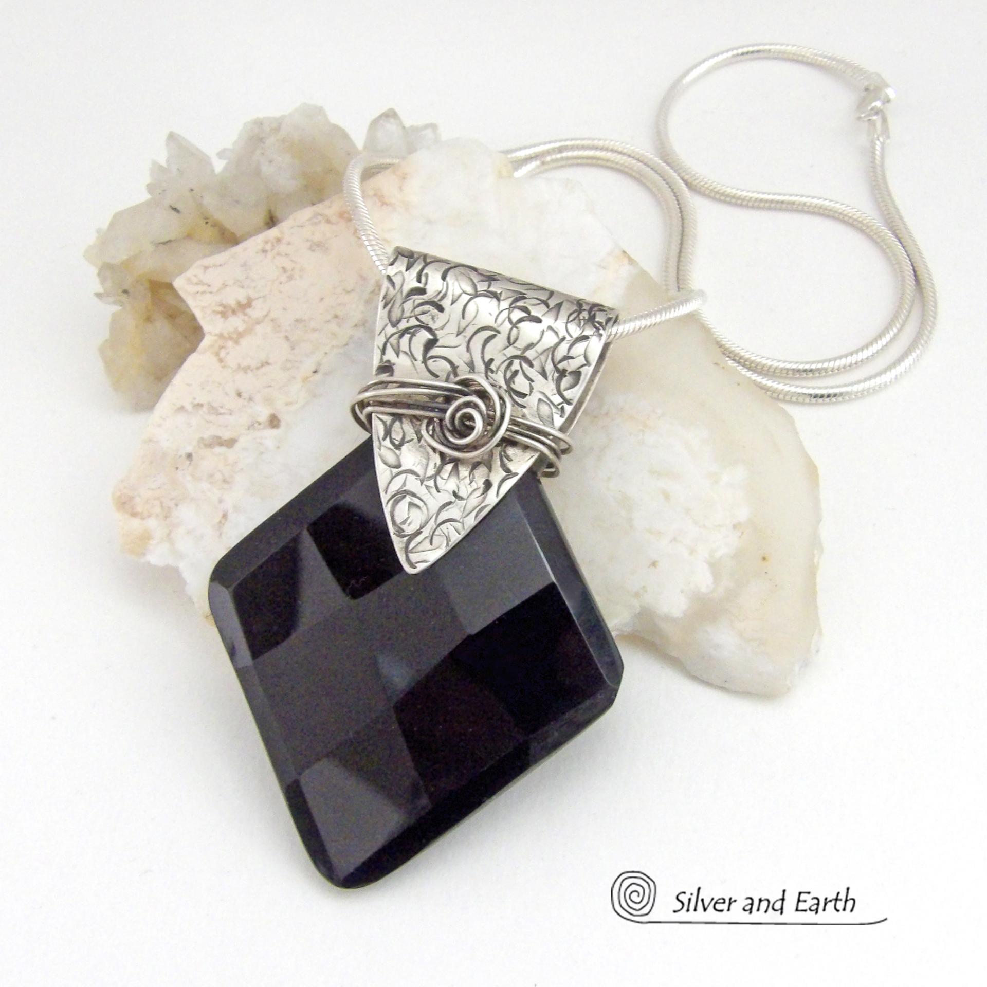 This handcrafted sterling silver necklace features a large, faceted black onyx gemstone accented with a handcrafted sterling bail. Perfect for any occasion – it will look great dressed up or down. The stone has been carved into a diamond shape and has a multi-faceted finish which casts off a natural sparkle and shine. Handmade in the USA by Silver and Earth Jewelry.