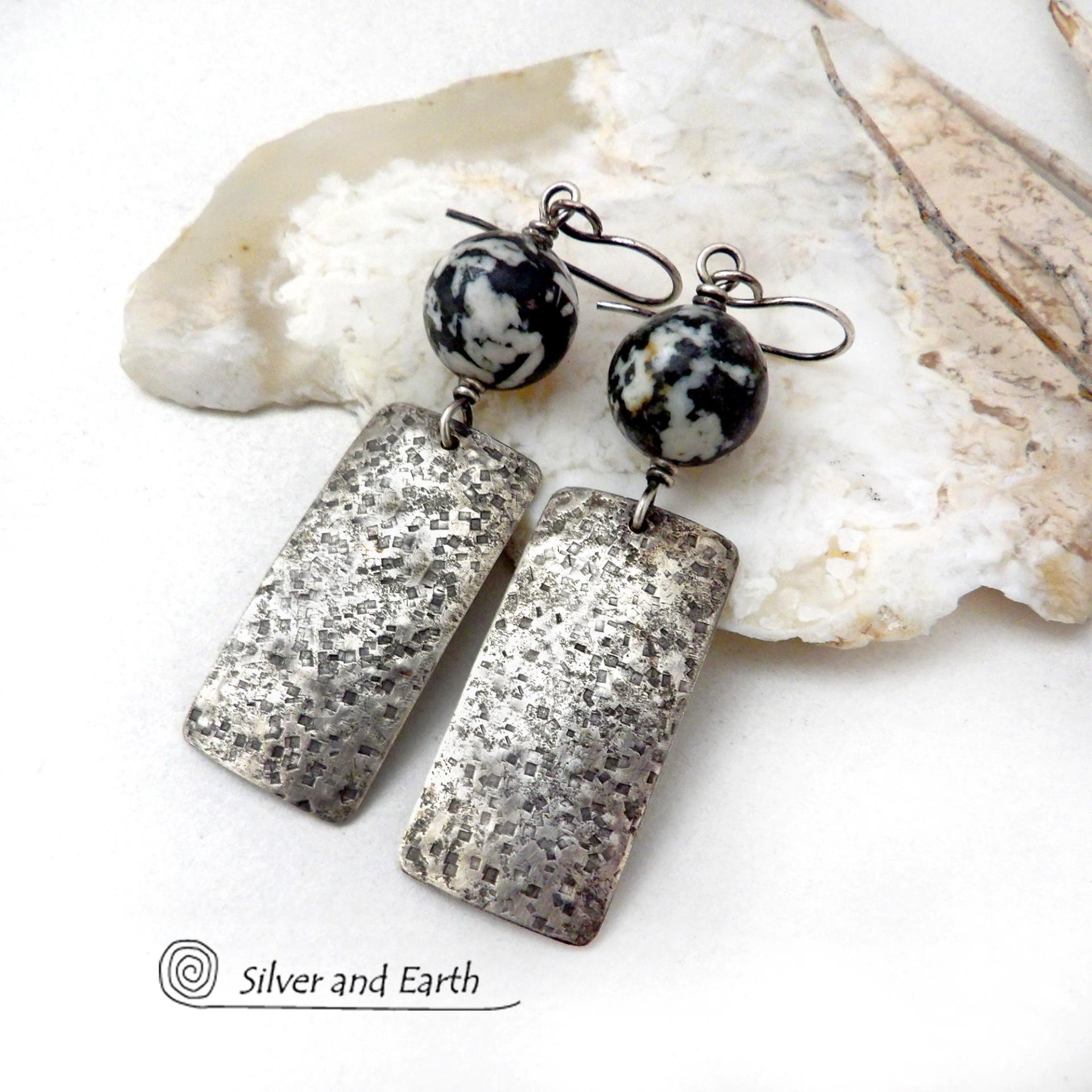 These sterling silver earrings have an earthy, organic and modern contemporary flair. They feature handcrafted sterling silver rectangles with a rustic hammered texture accented with round chunky agate gemstones. The stones have a striking natural matrix of white, gray and black speckles which create a granite-like effect. Unique and one-of-a-kind, they'll make a great gift for women that love bold unique jewelry and natural stones. 