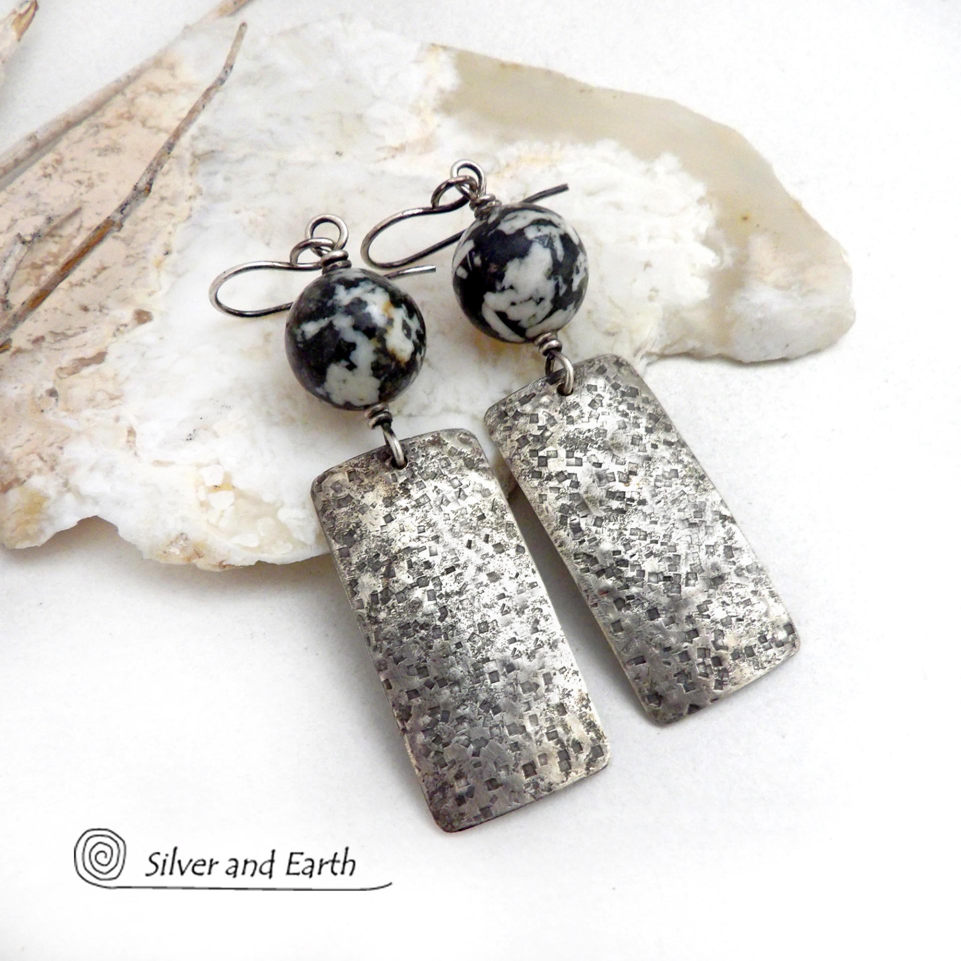 These sterling silver earrings have an earthy, organic and modern contemporary flair. They feature handcrafted sterling silver rectangles with a rustic hammered texture accented with round chunky agate gemstones. The stones have a striking natural matrix of white, gray and black speckles which create a granite-like effect. Unique and one-of-a-kind, they'll make a great gift for women that love bold unique jewelry and natural stones. 