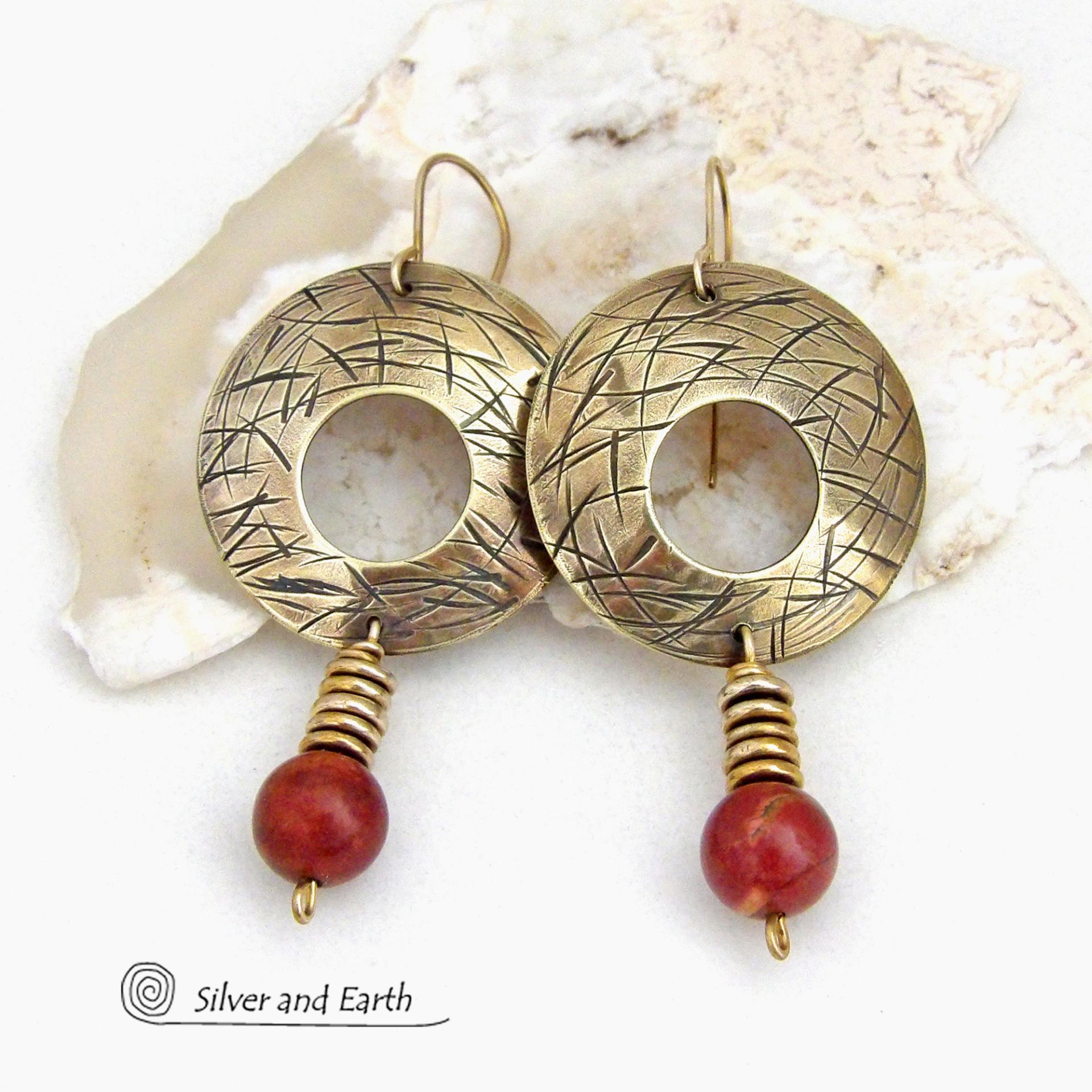 These handcrafted gold brass earrings have a hand stamped texture and are accented with dangling burgundy jasper gemstones and brass beads. Big and bold, they have a modern chic vibe that makes a striking eye-catching statement. Handmade in the USA by Silver and Earth Jewelry. 