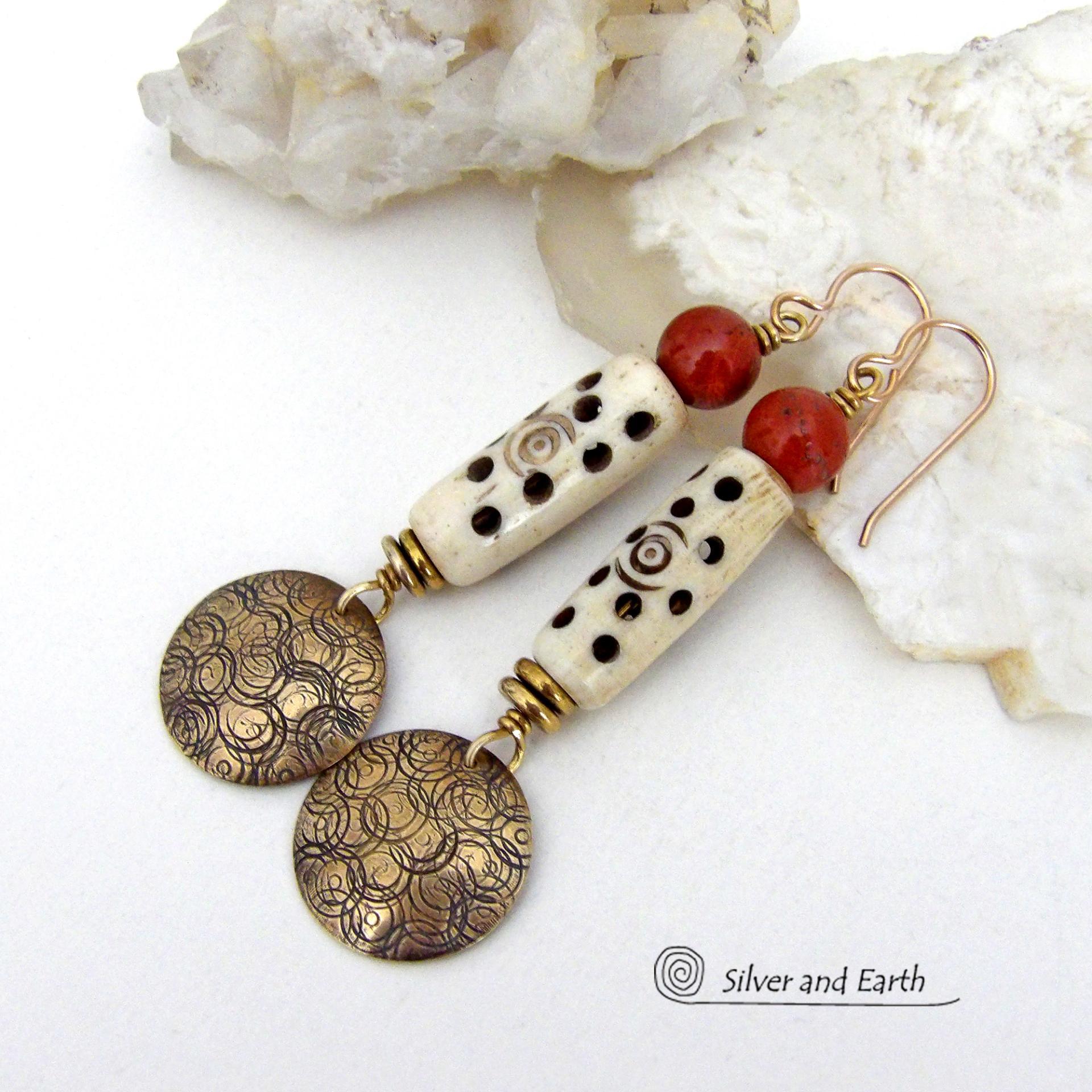 These handcrafted earrings feature a carved African bone beads, red jasper gemstones and textured gold brass dangles. Unique and striking, they have a boho chic style with lots of tribal flair. Perfect for women that love to wear bold unique artisan handmade jewelry. Handmade in the USA by Silver and Earth Jewelry. 
