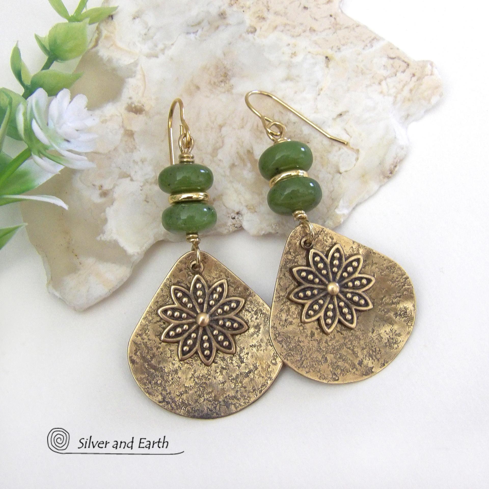 These handcrafted gold brass earrings have an earthy and modern nature-inspired charm. The design consists of brass fan-shaped dangles accented with Canadian green jade gemstones, brass flower charms and brass beads. The flowers have a lovely detailed texture and swing freely in front of the lightly hammered brass dangles. Perfect for your spring / summer wardrobe - or any time of year. They'll make a great gift for a nature and/or flower lover - or a nice addition to your own jewelry wardrobe. 