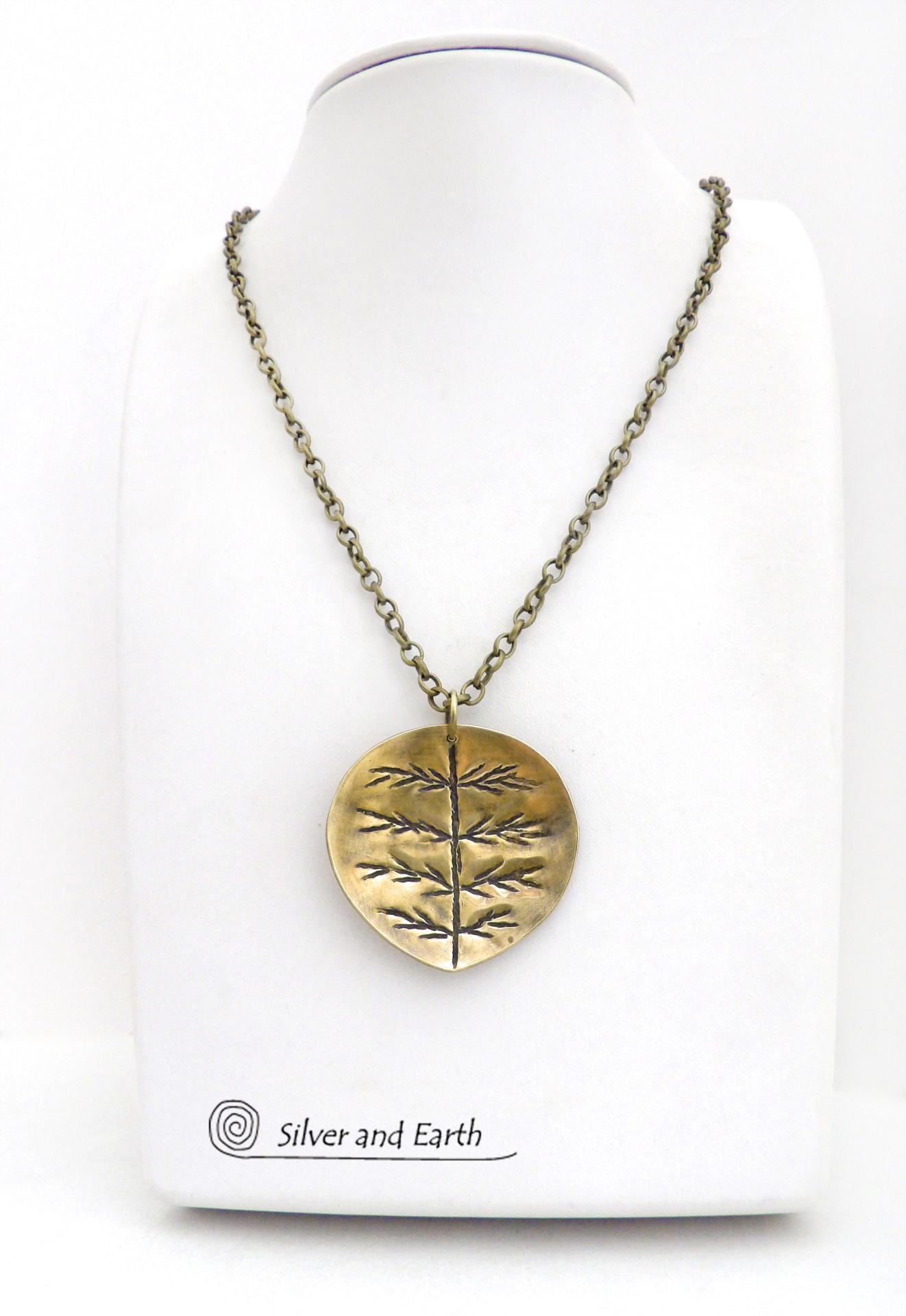 The perfect gift for nature lovers. This artisan handcrafted gold brass leaf pendant necklace has a modern earthy charm. It features a hand stamped texture pattern and comes on an 18" antiqued gold brass chain with lobster claw closure.