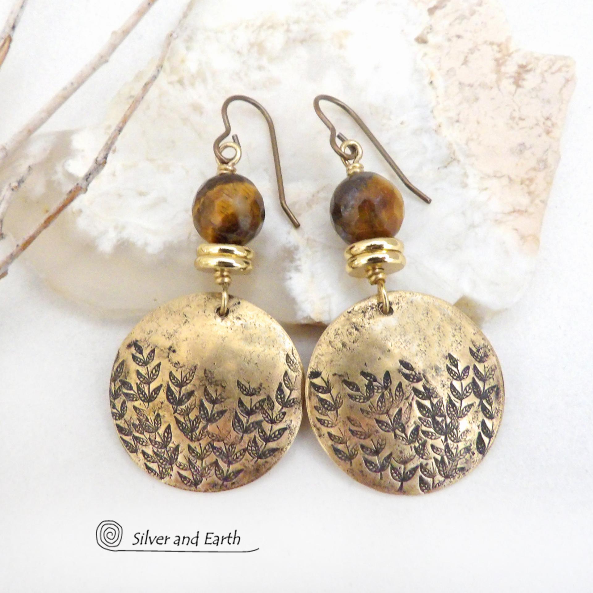 These handcrafted gold brass earrings feature a hand stamped leaf design and are accented with faceted tiger's eye gemstones and brass beads. They have an earthy, modern and elegant style that coordinates beautifully with all wardrobe types. They'll make a great gift for a nature lover - or a nice addition to your own jewelry wardrobe. These artisan-made earrings are perfect for adding a touch of earthy modern style to any outfit. 