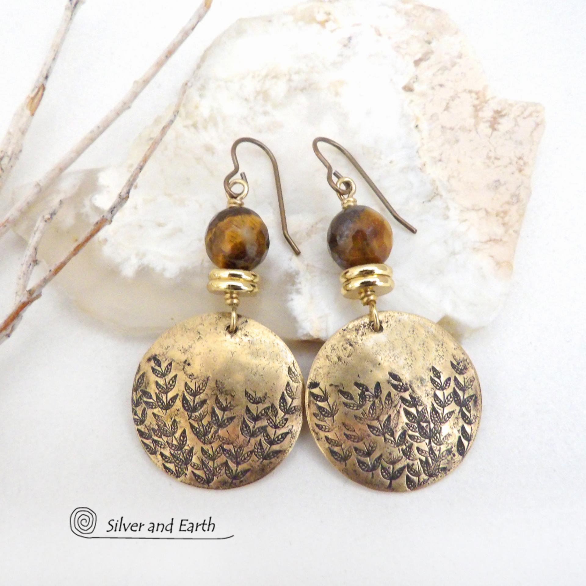These handcrafted gold brass earrings feature a hand stamped leaf design and are accented with faceted tiger's eye gemstones and brass beads. They have an earthy, modern and elegant style that coordinates beautifully with all wardrobe types. They'll make a great gift for a nature lover - or a nice addition to your own jewelry wardrobe. These artisan-made earrings are perfect for adding a touch of earthy modern style to any outfit. 