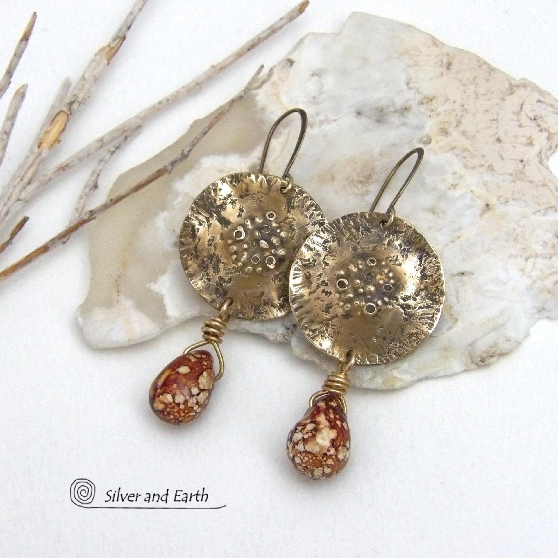 These handcrafted gold brass earrings have a modern, organic earthy style and are accented with natural brown spotted jasper gemstones. Bold, unique and one-of-a-kind - they make a striking statement with a modern edgy vibe. Perfect for women that love unique artisan handcrafted jewelry, earthy hammered textures and natural stones. Handmade in the USA by Silver and Earth Jewelry.