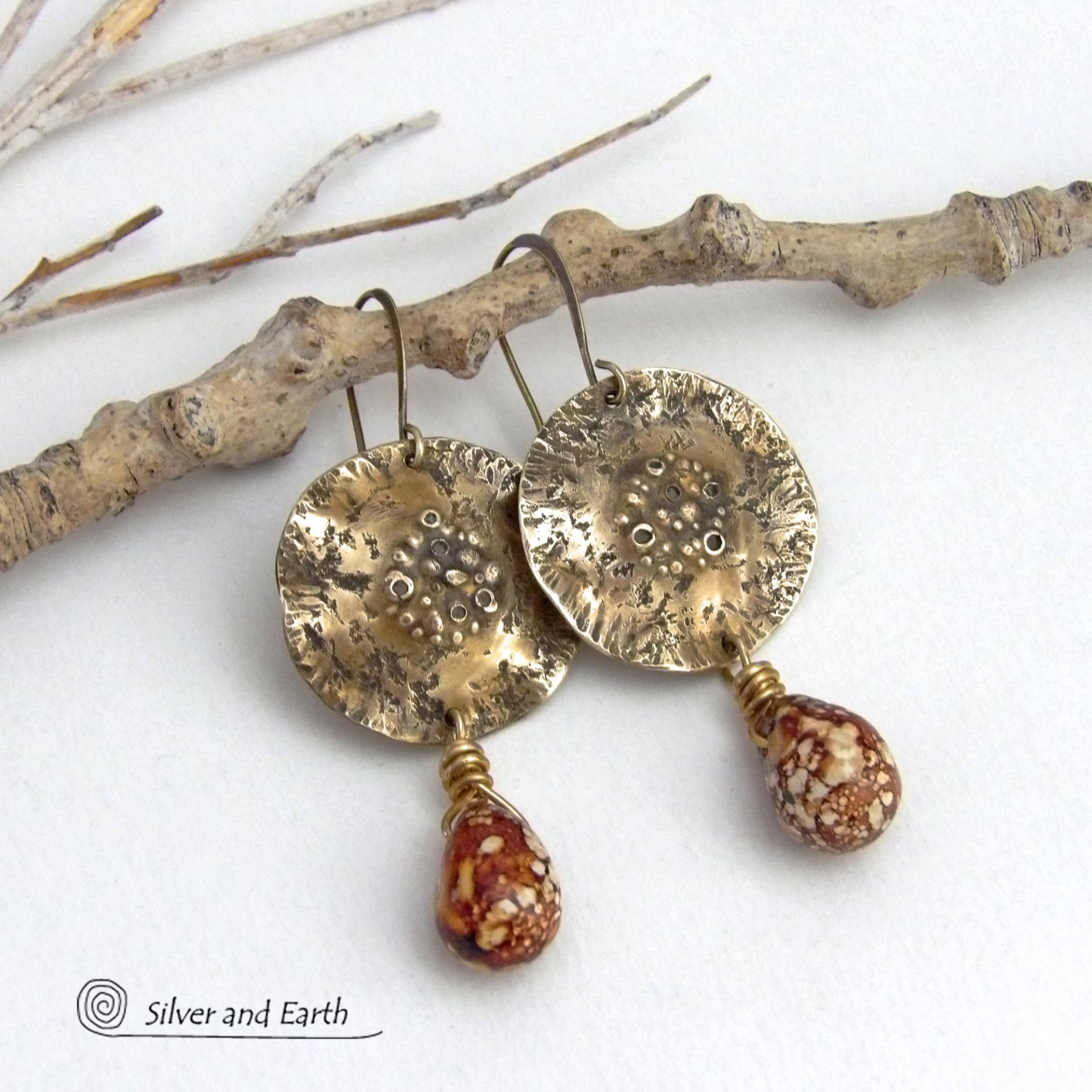 These handcrafted gold brass earrings have a modern, organic earthy style and are accented with natural brown spotted jasper gemstones. Bold, unique and one-of-a-kind - they make a striking statement with a modern edgy vibe. Perfect for women that love unique artisan handcrafted jewelry, earthy hammered textures and natural stones. Handmade in the USA by Silver and Earth Jewelry.