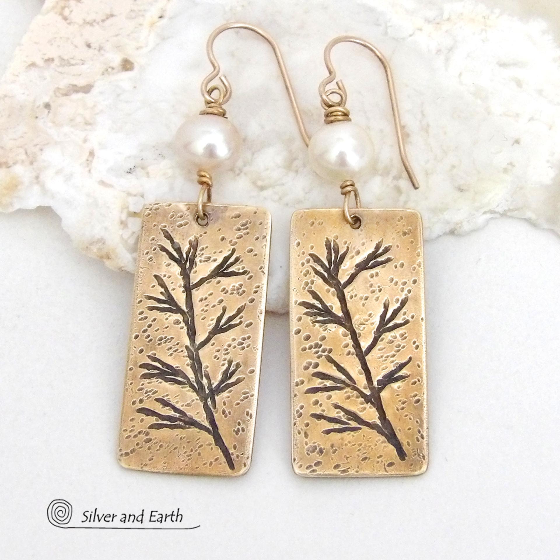 These artisan handmade earrings feature handcrafted gold brass rectangles with a hand stamped twig design accented with white pearls. They have a modern, earthy and elegant style and will make a great gift for a nature lover. They'll also make a great gift for someone born in June. Pearl is the traditional gemstone for this month. 