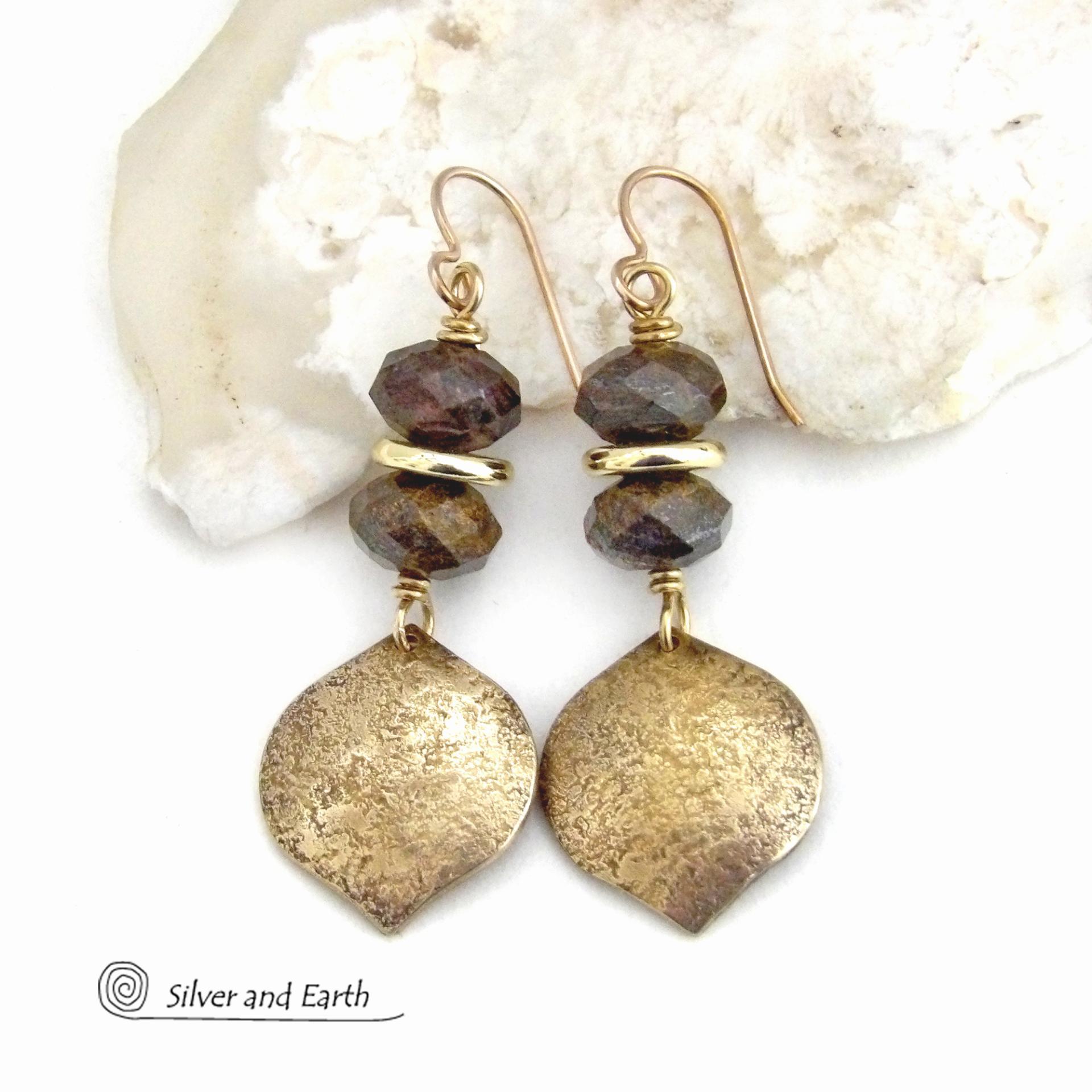 These handcrafted earrings feature gold brass dangles with a hammered organic texture accented with natural bronzite gemstones and shiny gold brass beads. The stones have a beautiful brown hue with a faceted finish which casts off a natural sparkle and shine. They have a modern chic style that coordinates beautifully with all wardrobe types - dressed up or down. A coordinating necklace is available that is sold separately.  Handmade in the USA by Silver and Earth Jewelry.