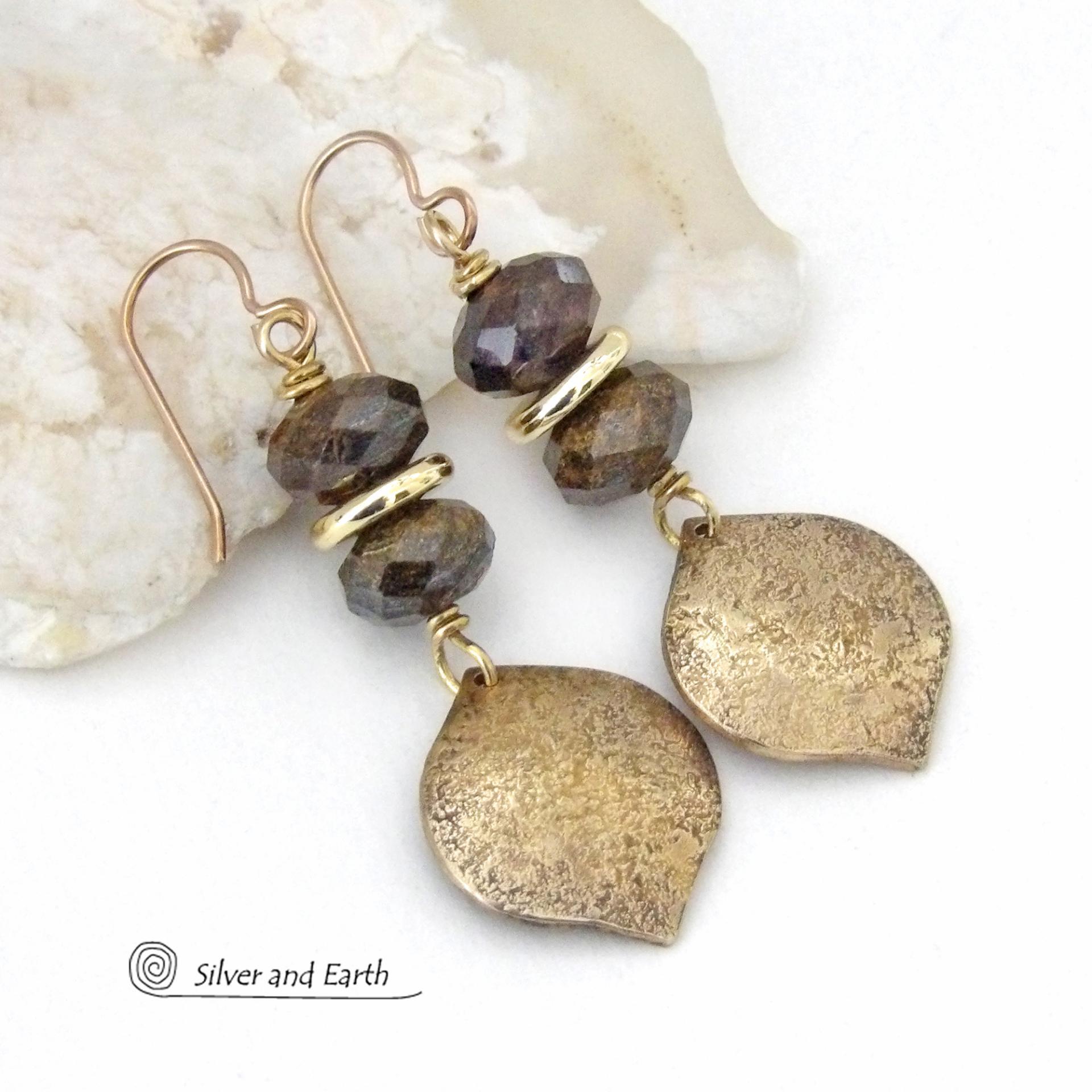 These handcrafted earrings feature gold brass dangles with a hammered organic texture accented with natural bronzite gemstones and shiny gold brass beads. The stones have a beautiful brown hue with a faceted finish which casts off a natural sparkle and shine. They have a modern chic style that coordinates beautifully with all wardrobe types - dressed up or down. A coordinating necklace is available that is sold separately.  Handmade in the USA by Silver and Earth Jewelry.