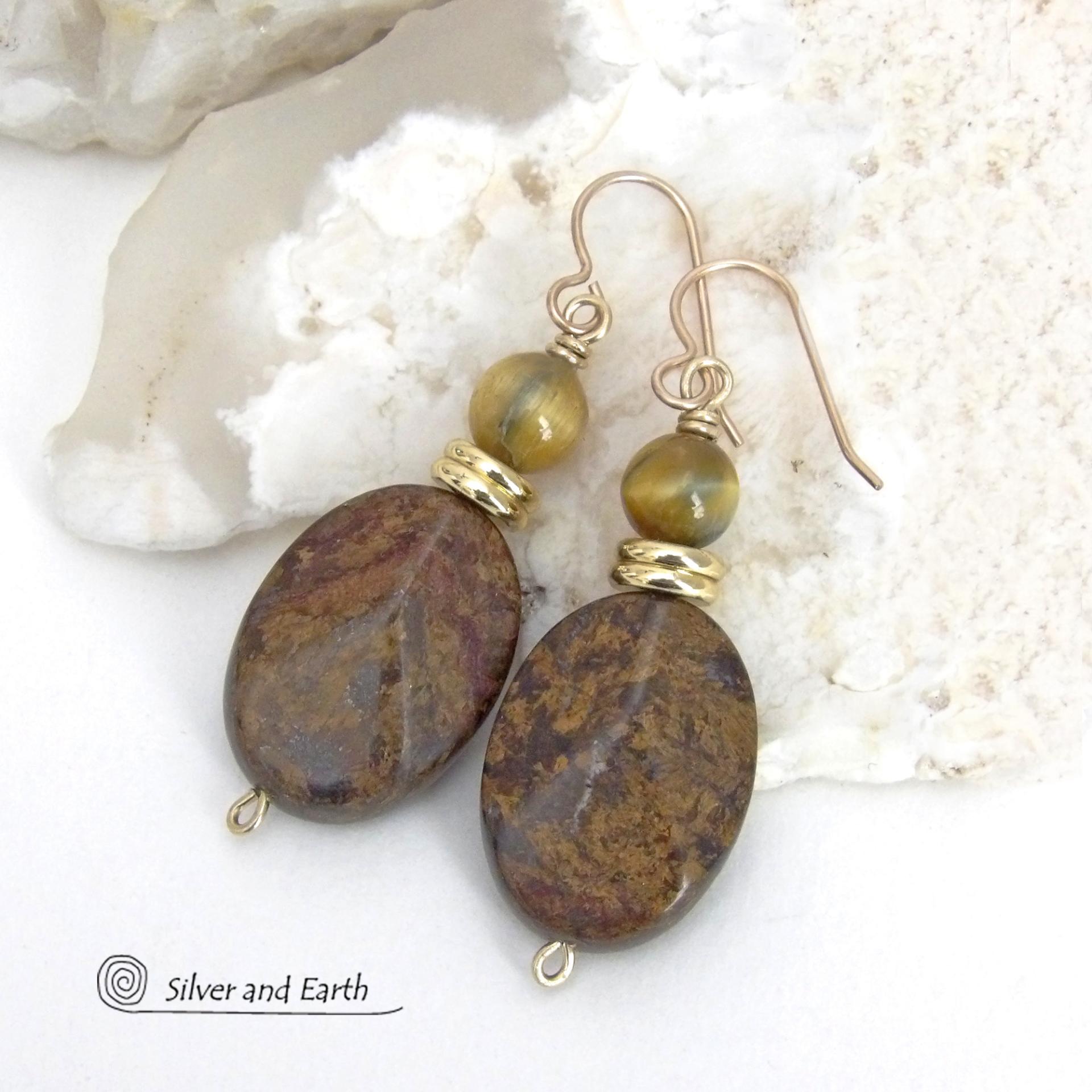 These handcrafted earrings feature natural bronzite gemstones with a faceted finish accented with golden tiger's eye gemstones and shiny brass beads. The bronzite stones have a beautiful chocolate brown hue with subtle *gold tone* metallic inclusions. Bronzite is a blend of several minerals which gives it a unique mottled appearance. They have a modern, earthy appeal and will make a great gift for a nature lover - or an interesting addition to your own jewelry wardrobe. Handmade in the USA by Silver and Ear
