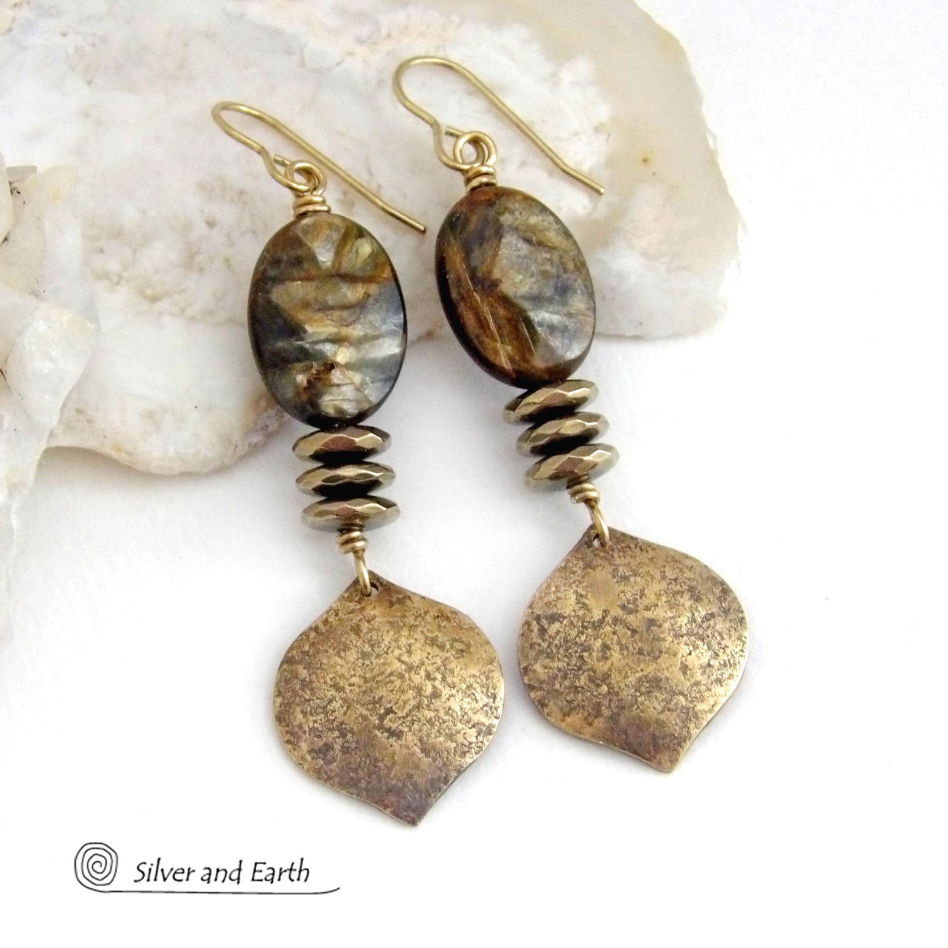 These handcrafted earrings feature gold brass dangles with a hammered organic texture accented with natural brown mica gemstones and faceted hematite stones with an electroplated champagne gold finish. The stones have a beautiful brown hue with undertones of shimmery gold and a faceted finish which casts off a natural sparkle and shine. They have a modern, chic and elegant style that coordinates beautifully with all wardrobe types - dressed up or down.