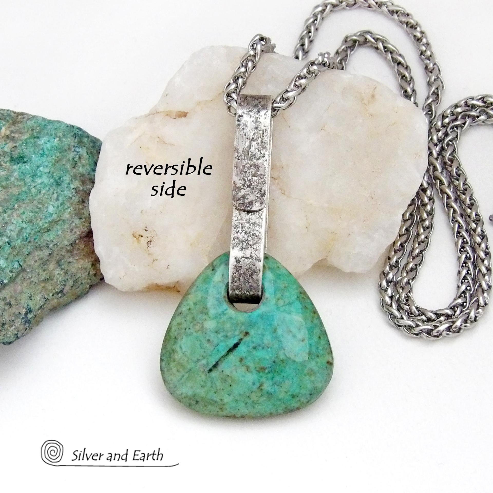 This one-of-a-kind pendant necklace features a beautiful chunky natural chrysocolla gemstone with a faceted finish. The stone is a beautiful shade of bluish-green which resembles turquoise. It hangs from a hand forged solid sterling silver bail with a lightly hammered organic texture. It's reversible. Unique and one-of-a-kind, it's sure to make a statement. Handmade in the USA by Silver and Earth Jewelry.