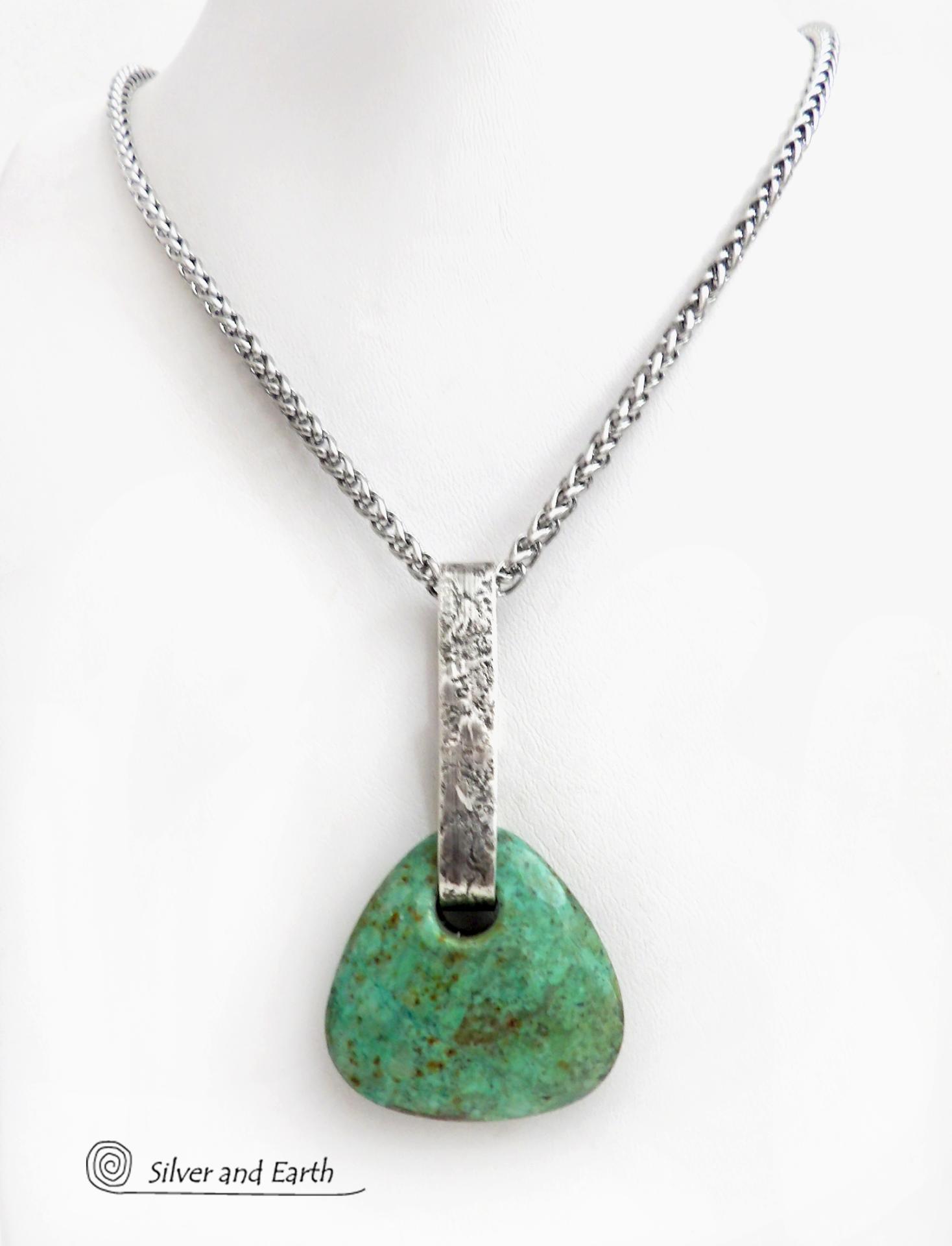 This one-of-a-kind pendant necklace features a beautiful chunky natural chrysocolla gemstone with a faceted finish. The stone is a beautiful shade of bluish-green which resembles turquoise. It hangs from a hand forged solid sterling silver bail with a lightly hammered organic texture. The pendant is reversible. (See all photos for alternate sides). Unique and one-of-a-kind, it's sure to make a statement. Makes a great gift for a natural stone lover - or a nice addition to your own jewelry wardrobe. Handmade