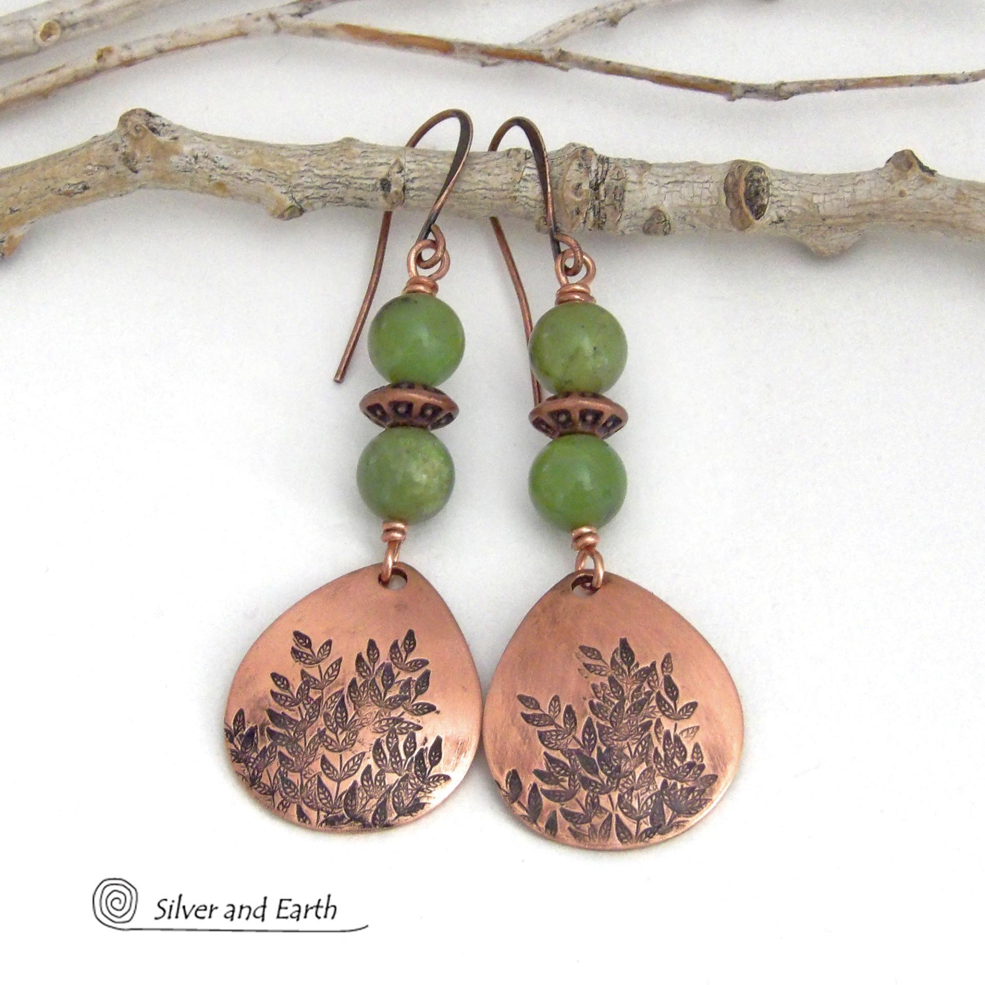 These handcrafted earrings feature teardrop shaped copper dangles with a hand-stamped leaf texture accented with natural green jade gemstones and copper beads. They have an earthy, modern style that coordinates well with all wardrobe styles. They'll make a great gift for a nature lover - or a nice addition to your own jewelry wardrobe. Your choice of copper ear wires or niobium hypoallergenic ear wires. Earrings are handmade in the USA by Silver and Earth Jewelry. 