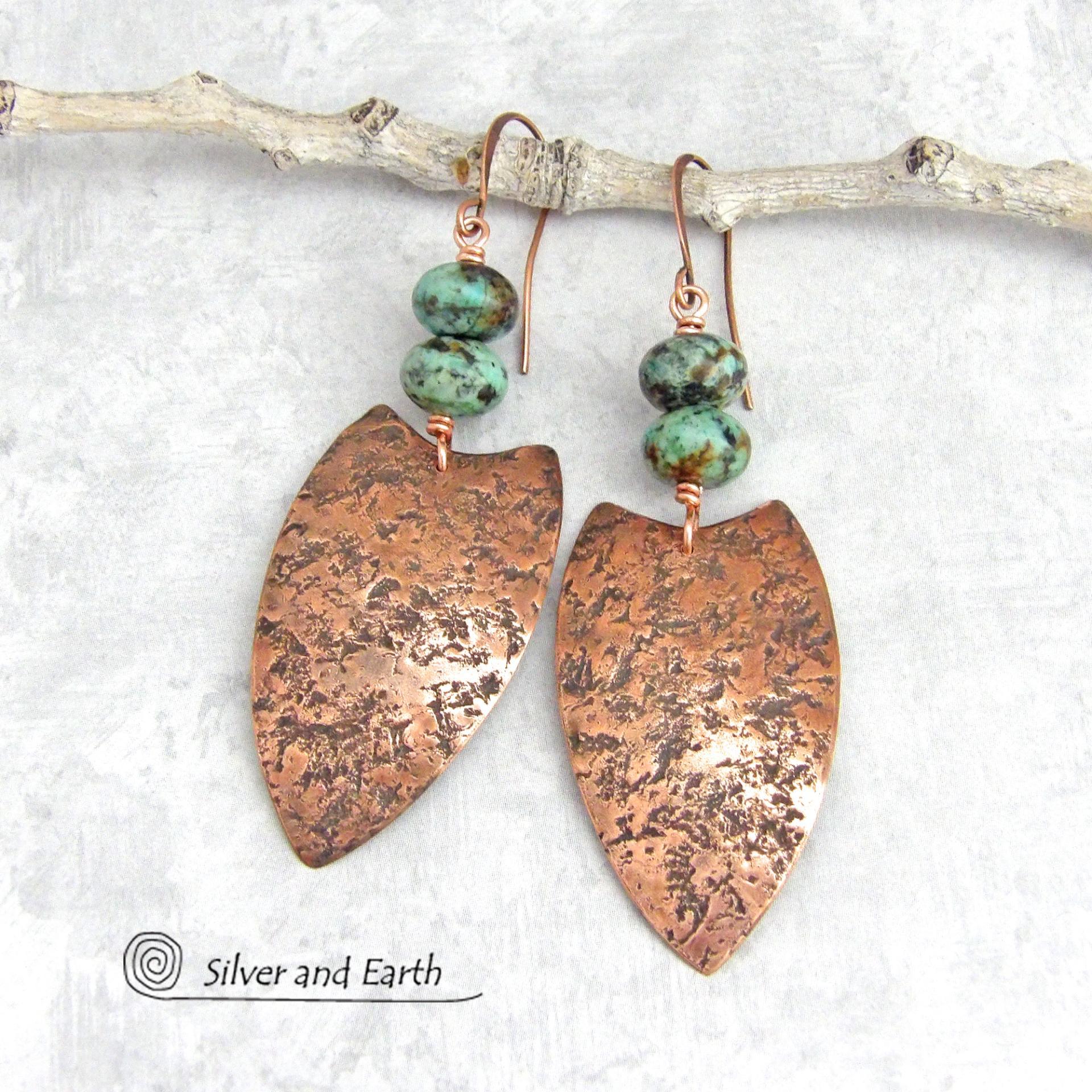 These large copper earrings feature handcrafted copper shields with a rustic, organic hammered texture accented with earthy, natural African turquoise stones. Big and bold, they have an ethnic tribal vibe and will make a striking statement. 