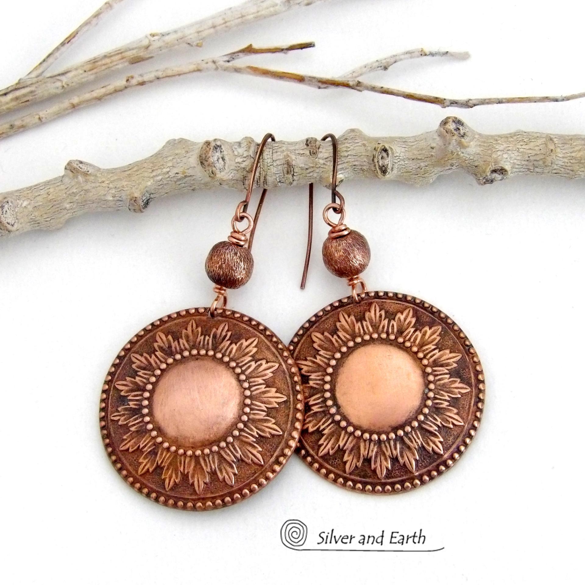 These handcrafted copper earrings have a beautifully detailed embossed sun medallion texture with an oxidized finish and are accented with brushed satin copper beads. Big and bold, they'll make a striking statement. Unique and versatile, they are lightweight and comfortable to wear and will look great with all wardrobe styles. Handmade in the USA by Silver and Earth Jewelry.