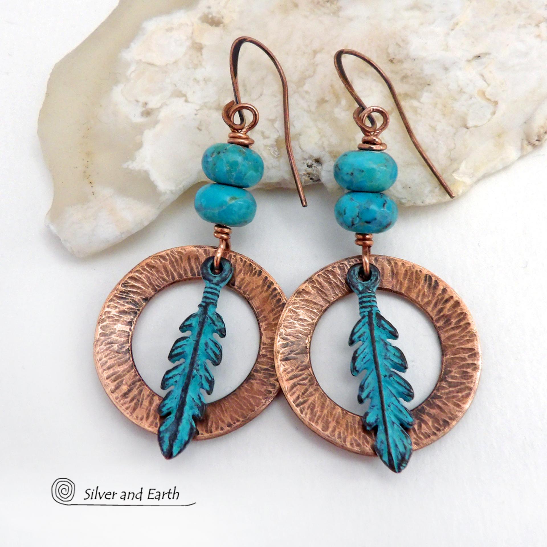 These handcrafted earrings feature round copper hoops with a hammered texture accented with a stack of turquoise beads and patina blue verdigris feathers. Lightweight and comfortable to wear - they'll add a touch of boho southwestern style to your wardrobe. Handmade in the USA by Silver and Earth Jewelry. 