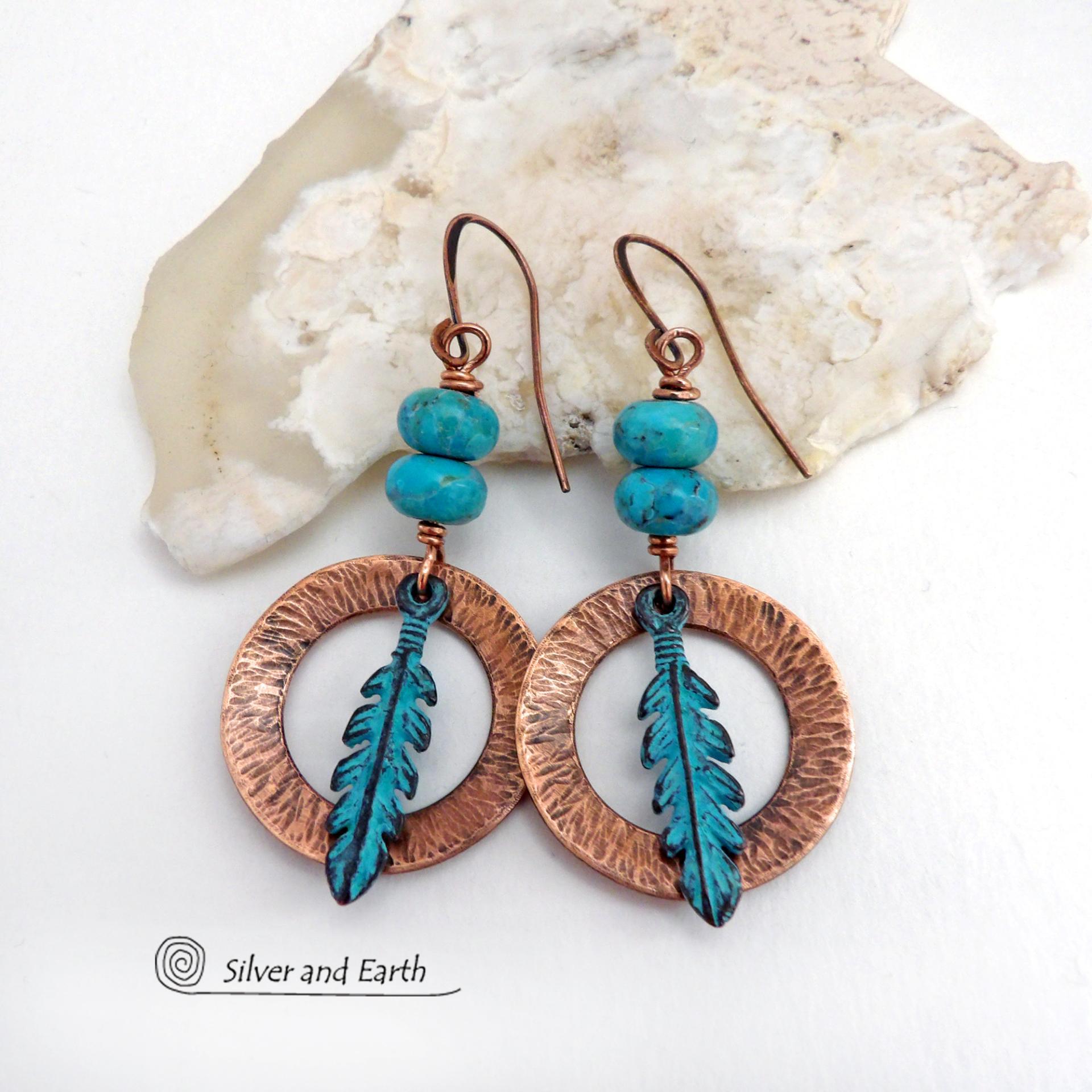 These handcrafted earrings feature round copper hoops with a hammered texture accented with a stack of turquoise beads and patina blue verdigris feathers. Lightweight and comfortable to wear - they'll add a touch of boho southwestern style to your wardrobe. Handmade in the USA by Silver and Earth Jewelry. 