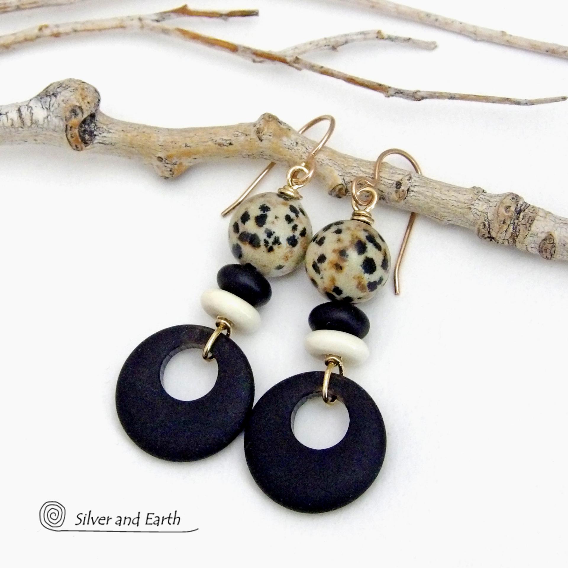 These handcrafted earrings feature matte black glass circle hoops accented with Dalmatian jasper gemstones, African bone and black glass beads. Unique and fun to wear, they have an earthy natural style with boho chic flair that makes a striking statement. They'll make a great gift for a natural stone lover - or a nice addition to your own jewelry wardrobe. Handmade in the USA by Silver and Earth Jewelry. 