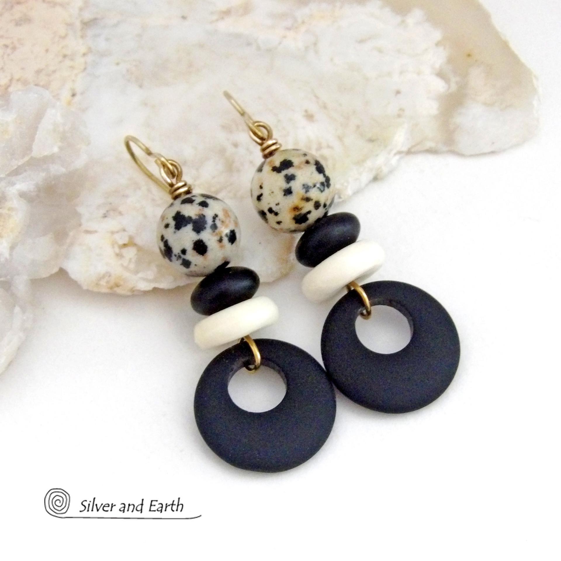 These handcrafted earrings feature matte black glass circle hoops accented with Dalmatian jasper gemstones, African bone and black glass beads. Unique and fun to wear, they have an earthy natural style with boho chic flair that makes a striking statement. They'll make a great gift for a natural stone lover - or a nice addition to your own jewelry wardrobe. 