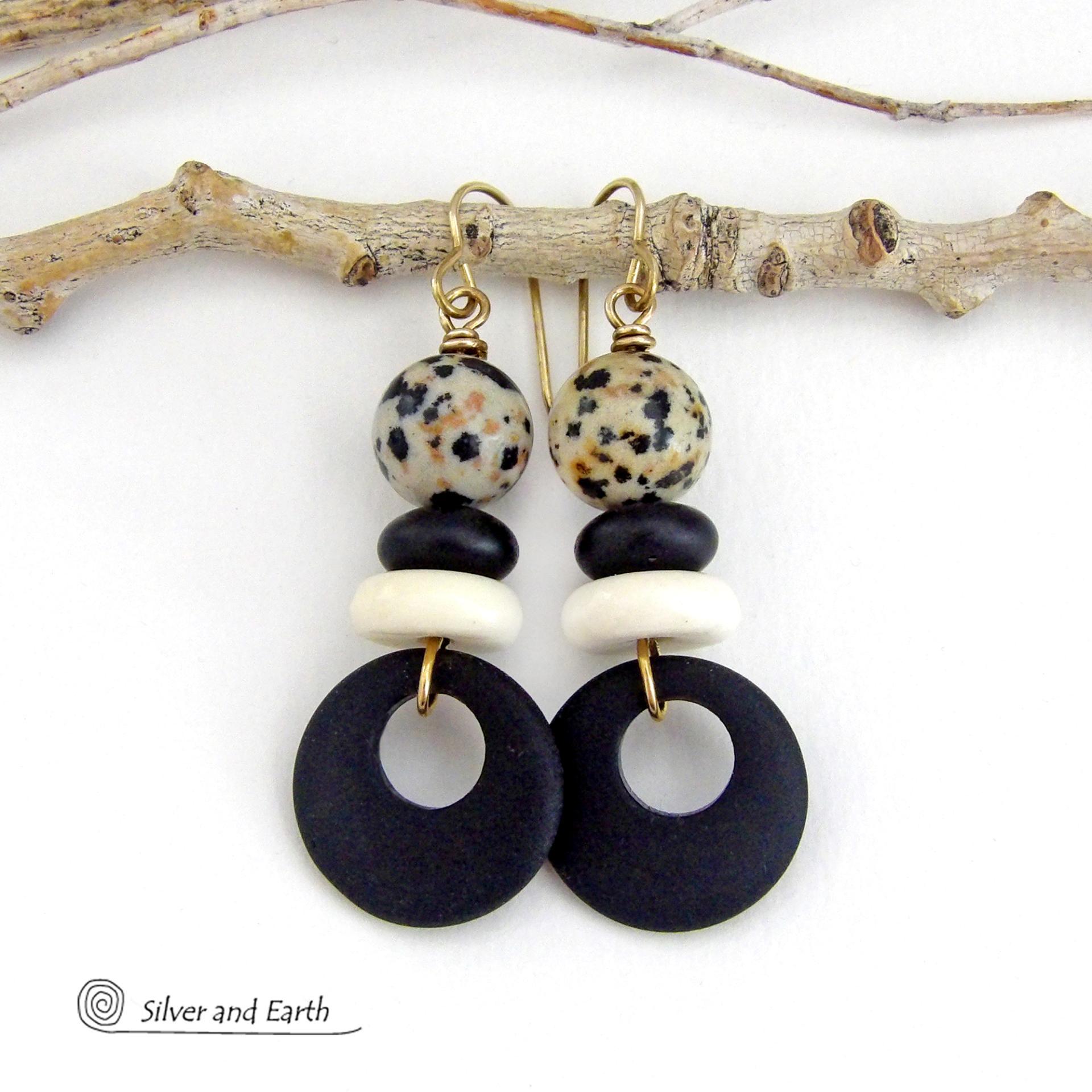 These handcrafted earrings feature matte black glass circle hoops accented with Dalmatian jasper gemstones, African bone and black glass beads. Unique and fun to wear, they have an earthy natural style with boho chic flair that makes a striking statement. They'll make a great gift for a natural stone lover - or a nice addition to your own jewelry wardrobe. 
