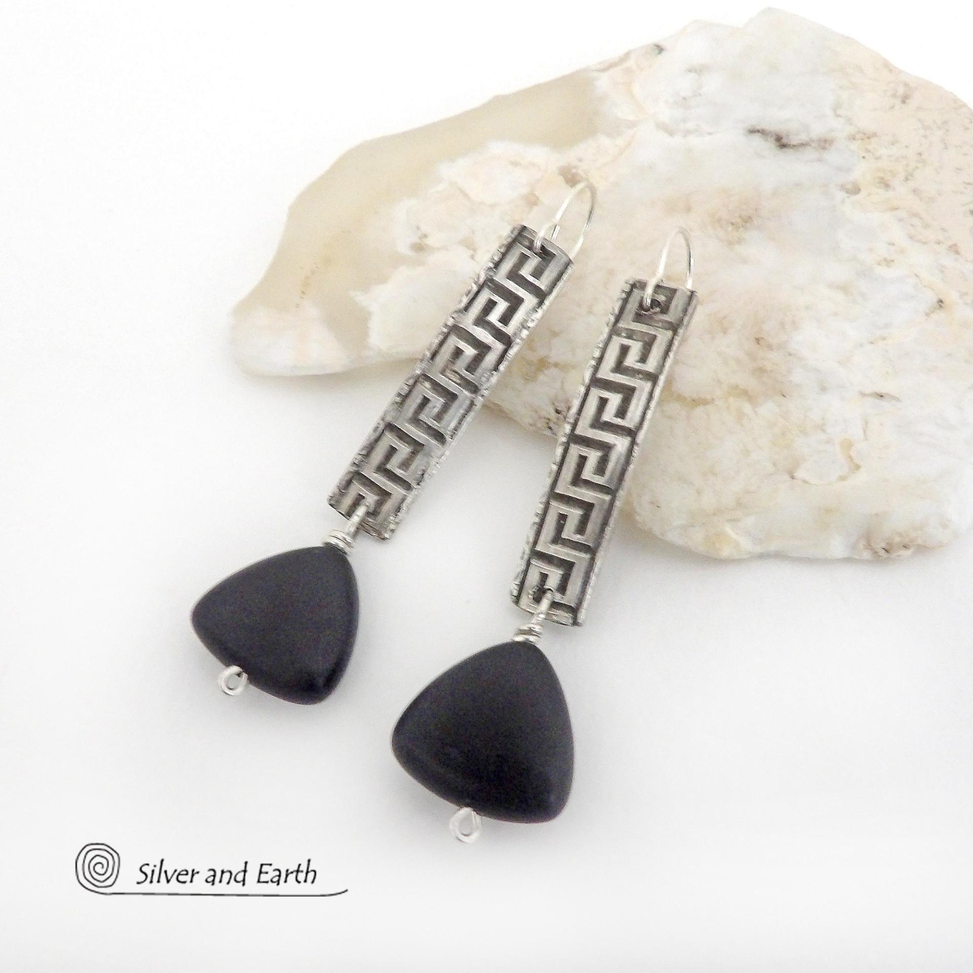 These handcrafted sterling silver earrings have a Greek key pattern and are accented with triangular-shaped black onyx stones with a matte finish. They have a contemporary modern vibe that coordinates beautifully with all wardrobe styles.Bold and unique, these earrings are perfect for women that love unusual jewelry. Handmade by SilverandEarth Jewelry.