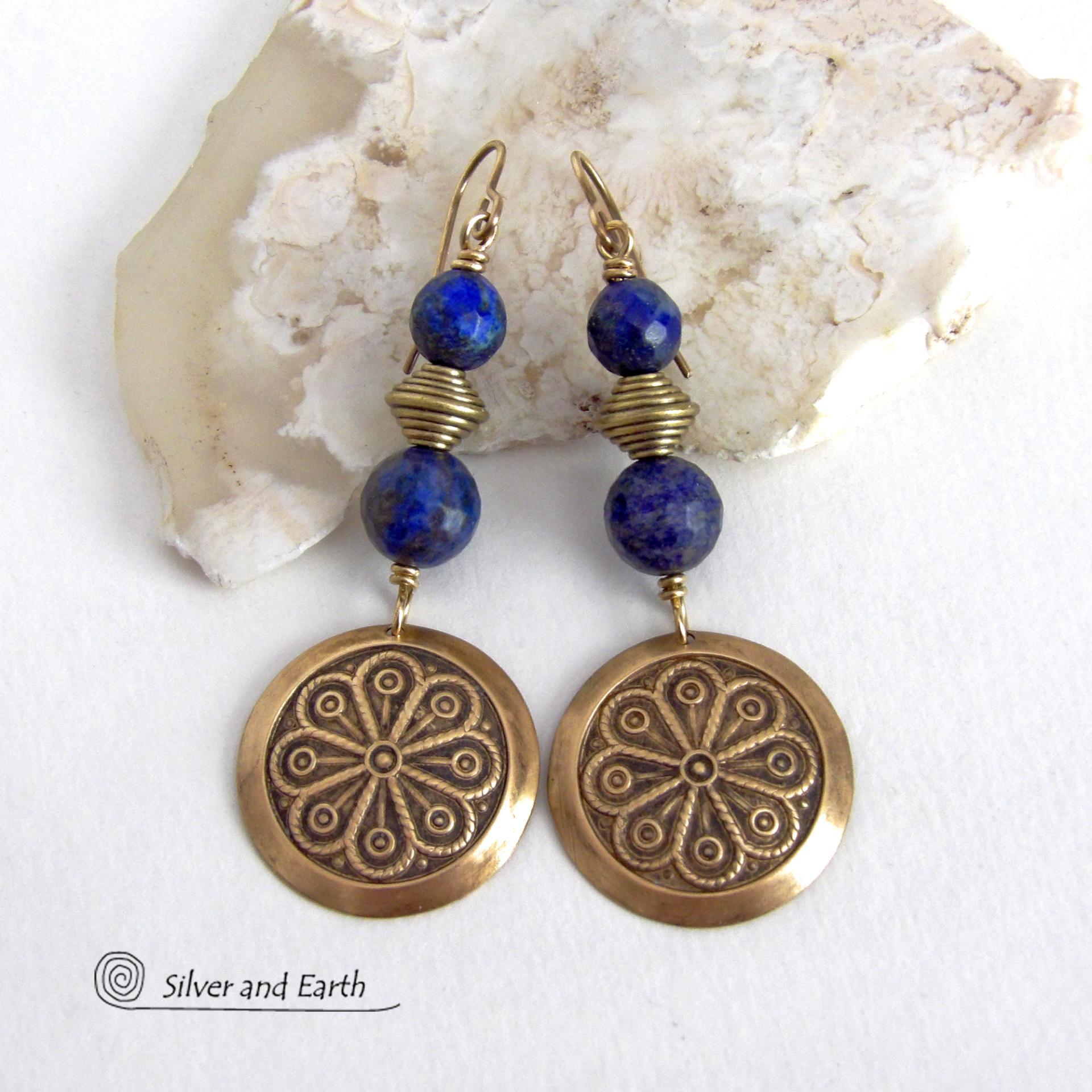 These handcrafted gold brass earrings have an exotic, Egyptian inspired vibe. They feature brass circle dangles with a beautiful embossed texture accented with faceted genuine lapis lazuli gemstones and textured brass beads. Bold and unique, they'll add a touch of cultural exotic charm to any type of wardrobe - dressed up or down. Perfect for women that love unique artisan handcrafted jewelry. Handmade in the USA by Silver and Earth Jewelry. 