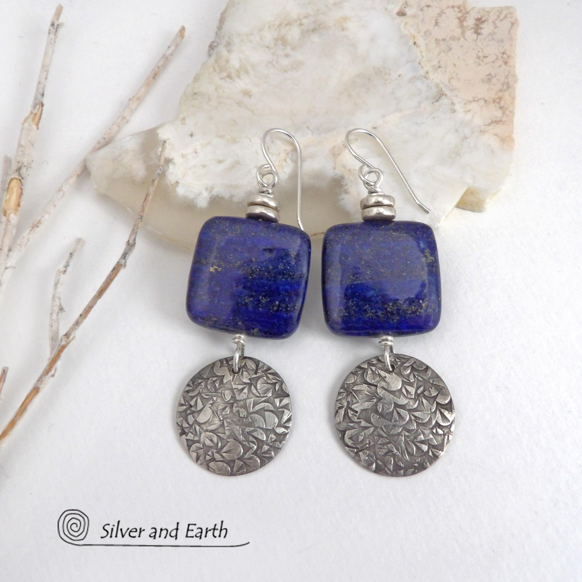 These earrings feature natural lapis lazuli gemstones accented with textured sterling silver dangles. The stones have a beautiful deep blue hue with natural pyrite inclusions. They are topped off with tiny pewter beads. The design is modern, classic, elegant and always in style. They'll coordinate beautifully with all wardrobe types. Handmade in the USA by Silver and Earth Jewelry. 