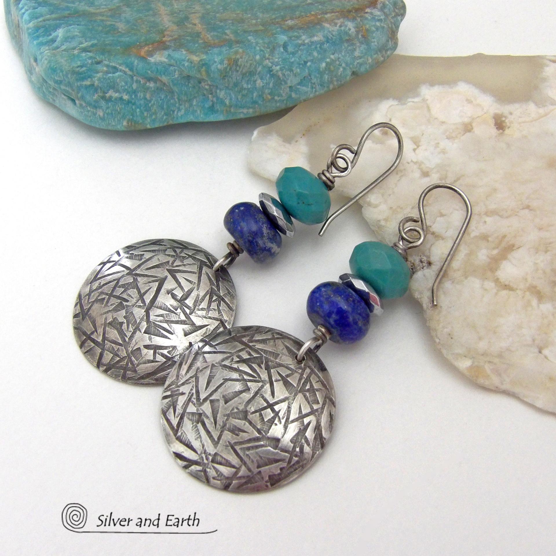 These handcrafted earrings feature sterling silver dangles with a hand stamped texture accented with faceted turquoise and lapis lazuli gemstones. Small hematite gemstones with a faceted finish were added for a touch of natural sparkle and shine. The earrings have a contemporary, modern chic style with a bit of southwestern flair. They'll coordinate beautifully with all wardrobe types - dressed up or down. Handmade in the USA by Silver and Earth Jewelry. 