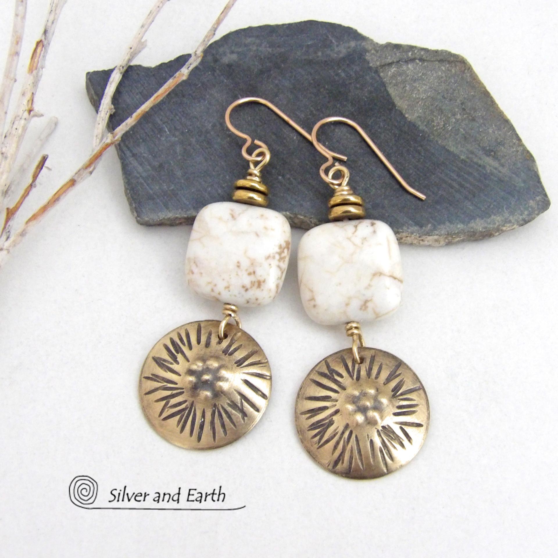 These gold brass dangle earrings have a unique hand textured design and are accented with creamy white magnesite stones. The stones have a natural matrix of golden-brown speckled inclusions and are topped off with tiny brass beads. I created the dangles out of solid gold brass sheet; and then created the texture which reminds me of the golden rays of the sun. The metal was oxidized to enhance the detail; then sealed with jeweler's wax to resist tarnishing.