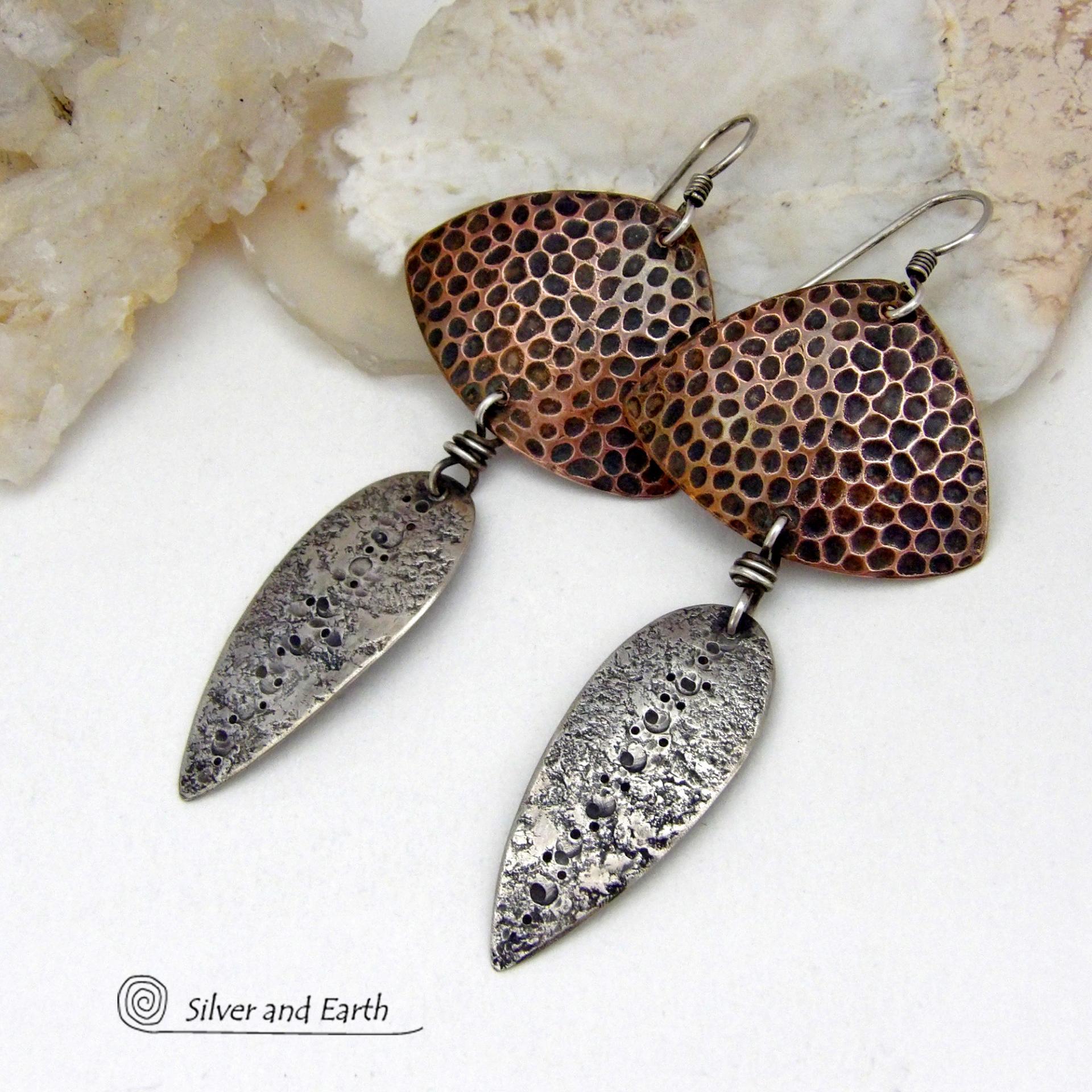 These sterling silver and copper mixed metal earrings have a modern, contemporary vibe. The copper has a dotted embossed pattern and the sterling dangles have a rustic hammered and stamped texture. Unique and versatile, the combination of metals will coordinate well with other copper and silver accessories in your wardrobe.