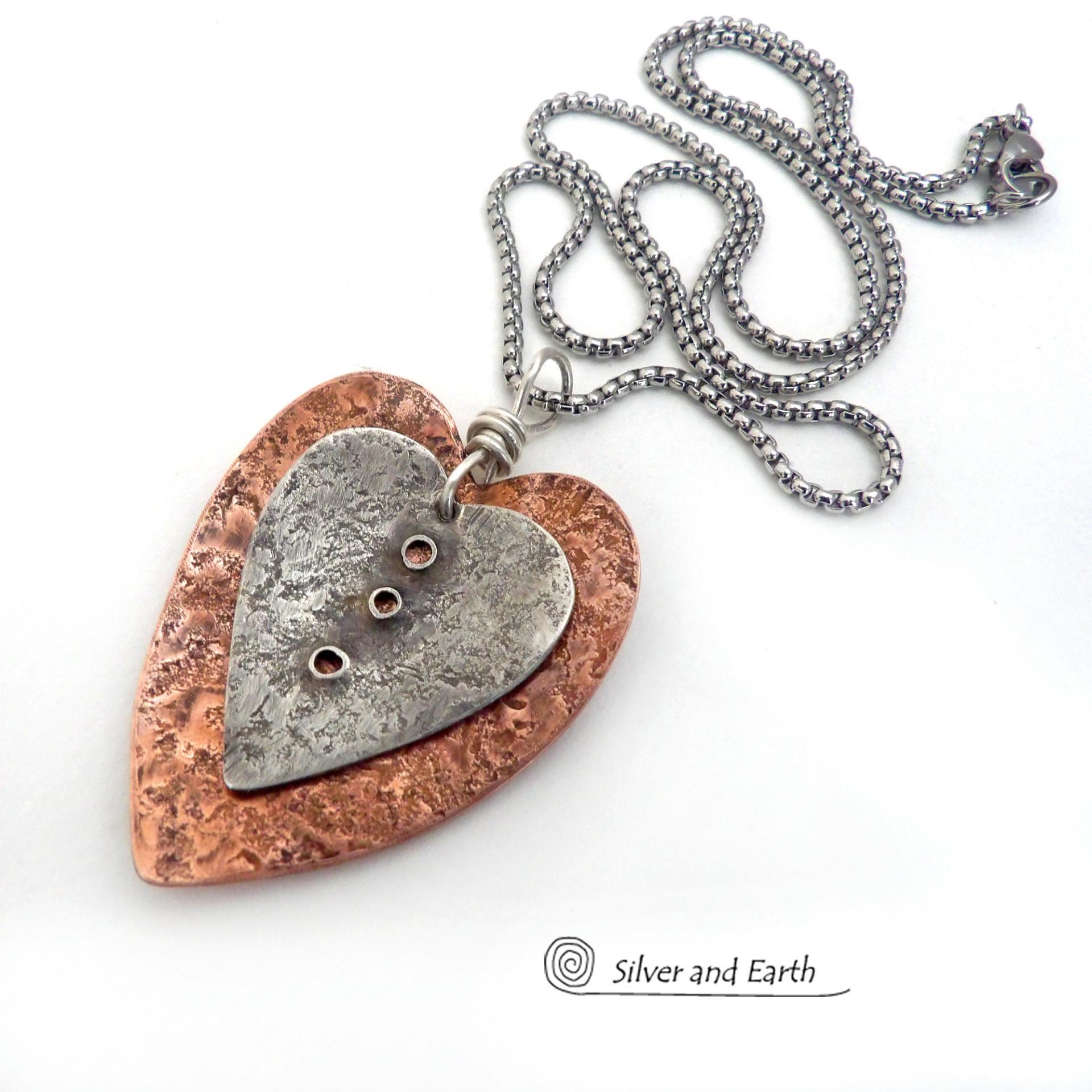 This mixed metal heart necklace has an earthy, rustic charm and will make a great gift for someone special. It features nesting hearts handcrafted from sterling silver and copper. It comes on a 20" stainless steel chain with lobster claw closure. The necklace holds a special significance as it represents two hearts coming together in union. This could be a meaningful gift for someone you love deeply.  The perfect gift for a wife, mom or girlfriend. Makes a great gift for couples celebrating their 7th weddin