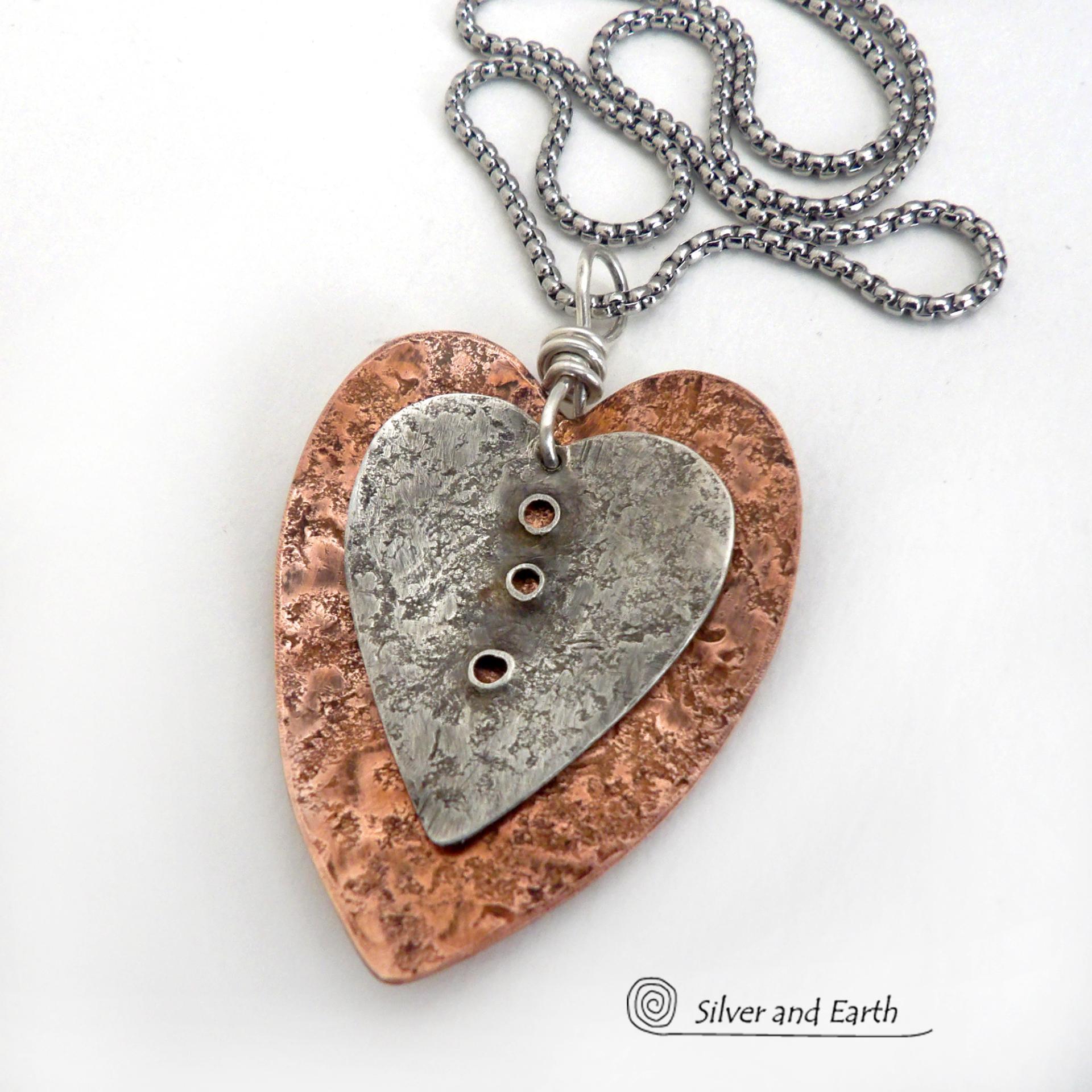 This mixed metal heart necklace has an earthy, rustic charm and will make a great gift for someone special. It features nesting hearts handcrafted from sterling silver and copper. It comes on a 20" stainless steel chain with lobster claw closure. The necklace holds a special significance as it represents two hearts coming together in union. This could be a meaningful gift for someone you love deeply.