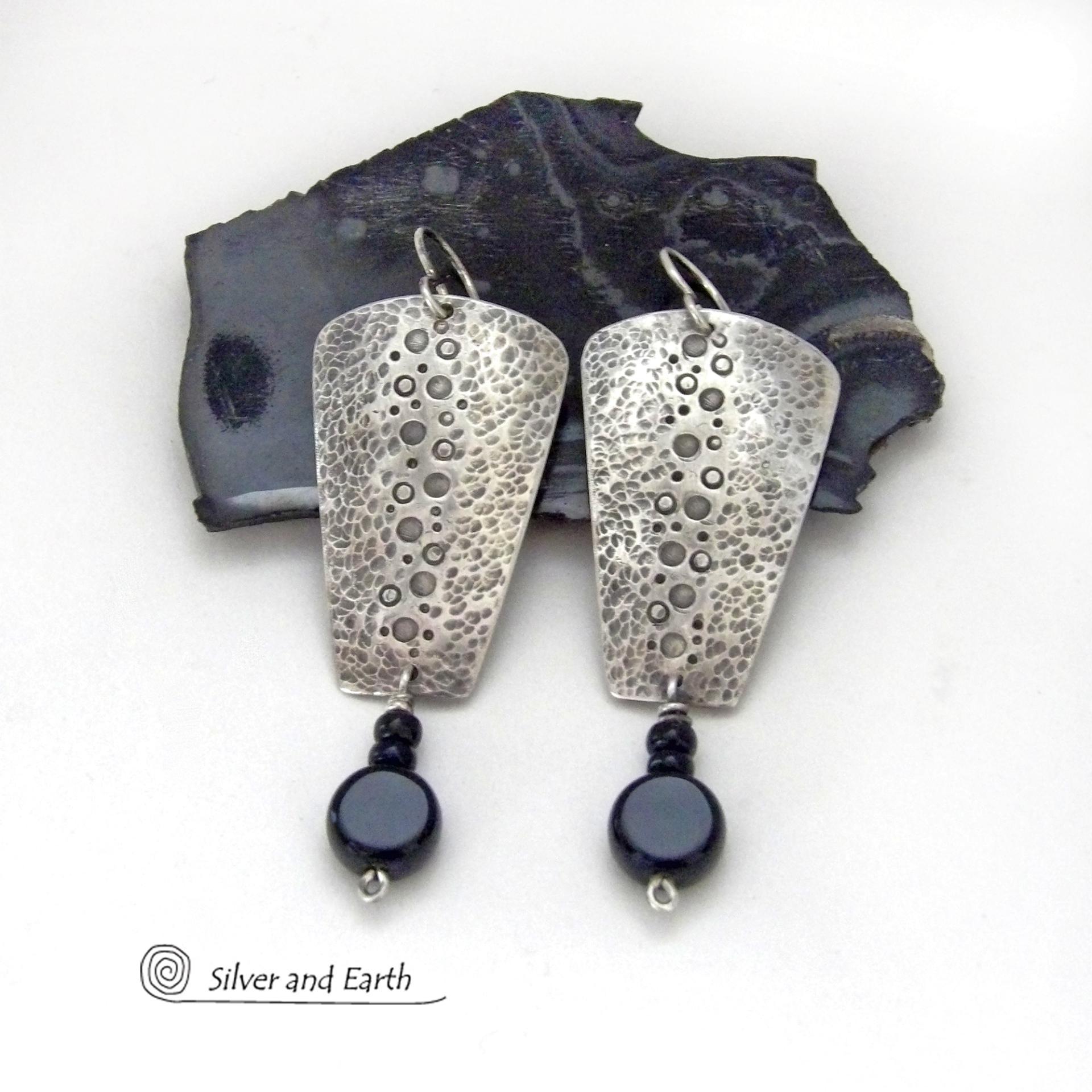 These handcrafted solid sterling silver earrings have a hammered and hand stamped texture and are accented with a dangling stack of black onyx gemstones. They have a rustic, edgy, organic vibe with a modern, contemporary style that makes a bold statement.
