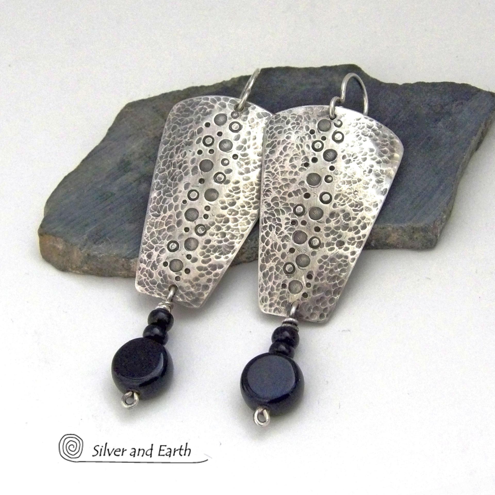 These handcrafted solid sterling silver earrings have a hammered and hand stamped texture and are accented with a dangling stack of black onyx gemstones. They have a rustic, edgy, organic vibe with a modern, contemporary style that makes a bold statement.