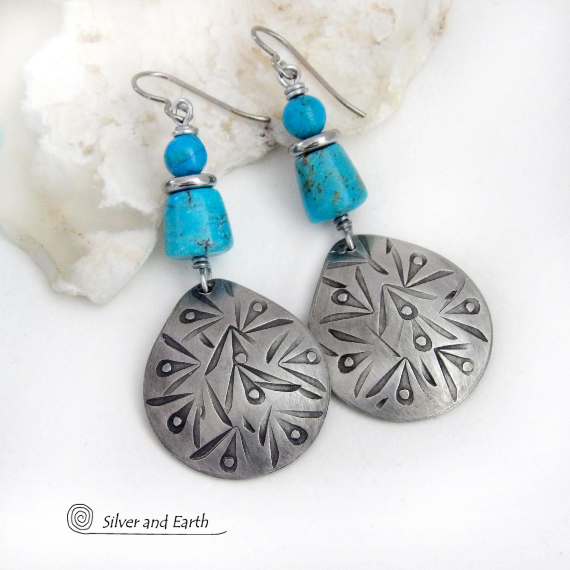These handcrafted earrings feature silver pewter teardrop-shaped dangles with a hand stamped texture accented with natural turquoise stones and stainless steel spacer beads. They have a bold modern style with southwestern flair and will make a striking statement. They'll make a great gift for anyone that loves natural turquoise stones and southwest style jewelry. Handmade in the USA by Silver and Earth Jewelry, a New Mexico True Certified business. 