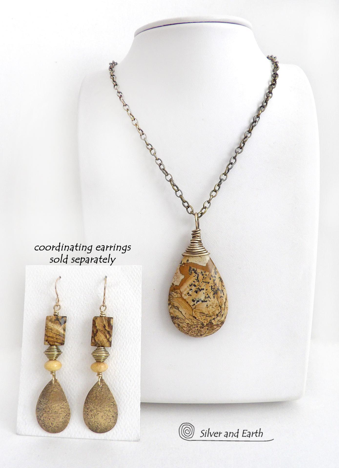 This one-of-a-kind necklace features a natural picture jasper stone wrapped in gold brass wire. The stone has an interesting matrix pattern with earthy hues of brown, tan and black. It has an earthy, simple style that coordinates beautifully with all wardrobe styles. It makes a great gift for a natural stone lover - or a nice addition to your own jewelry collection. Handmade in the USA by Silver and Earth Jewelry. Coordinating earrings sold separately.