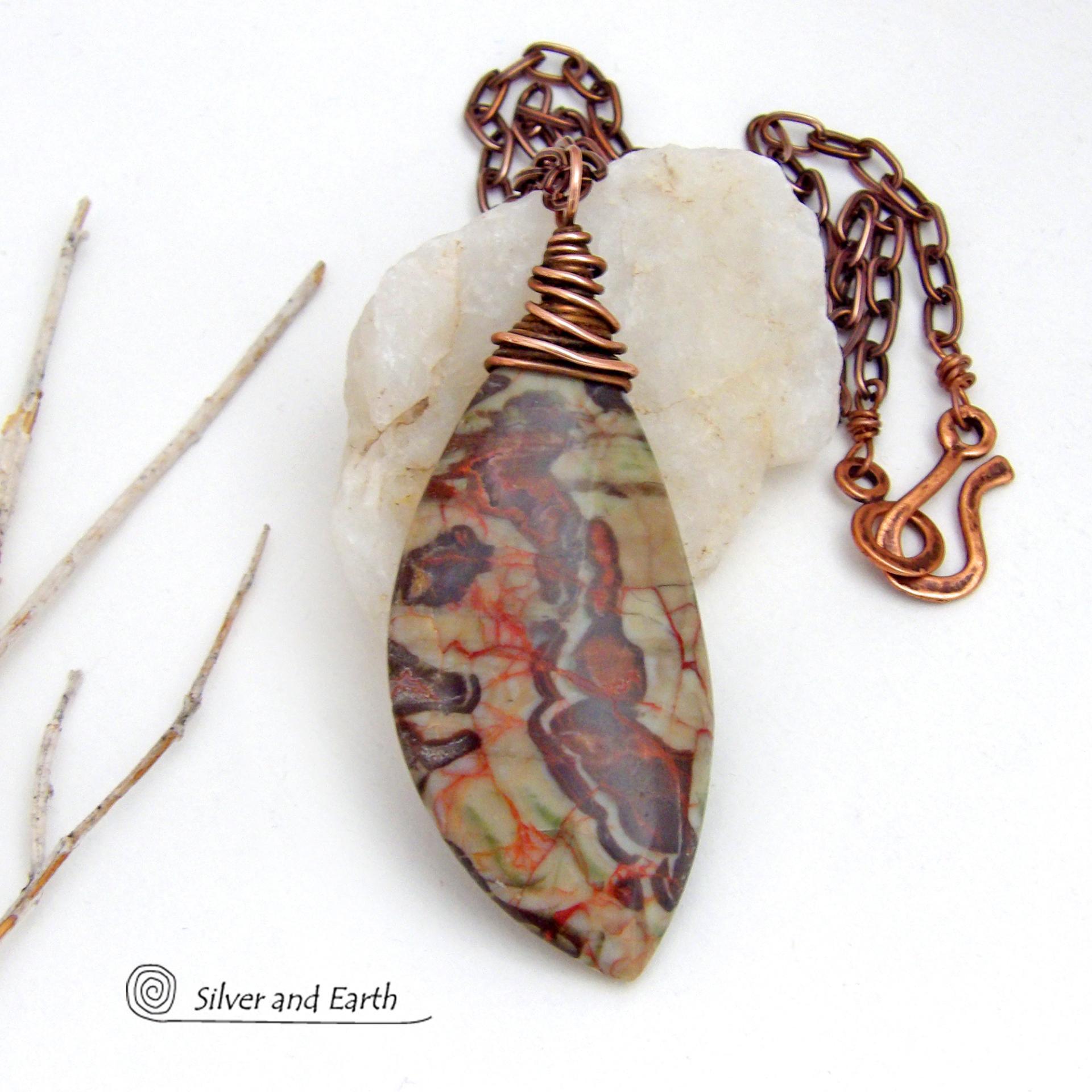 This necklace features a natural rhyolite jasper stone with a natural pattern in earthy hues of rusty orange, brown and taupe. It is wrapped in oxidized copper wire and comes on an 18" copper chain necklace. It has an earthy, natural style and will make a great gift for a natural stone lover - or a nice addition to your own jewelry collection. The chain can be removed from the pendant and worn with other pendants in your wardrobe. Coordinating earrings sold separately. 