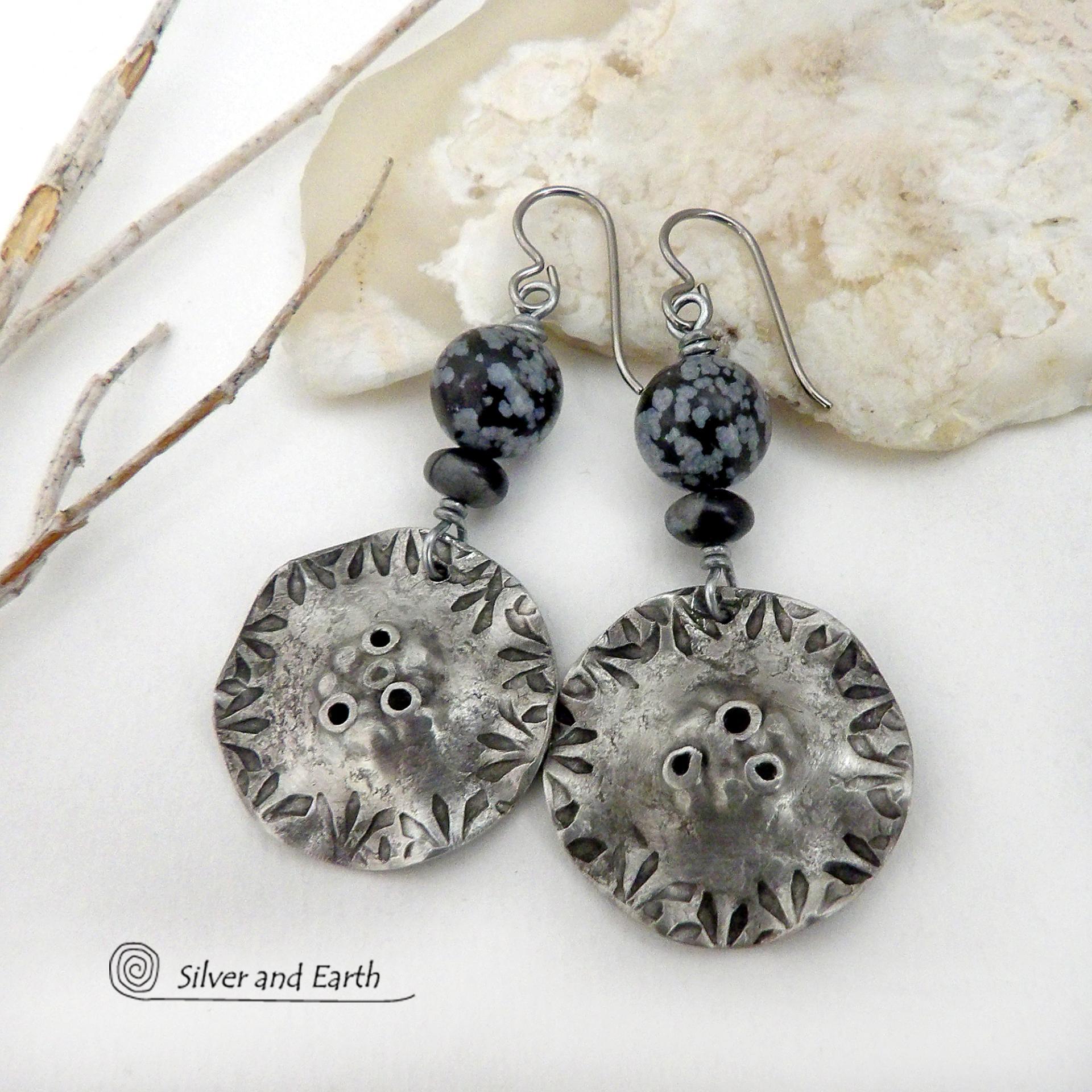 Handcrafted earrings with a modern bold edgy vibe. They feature rustic hammered and hand stamped silver tone pewter dangles accented with natural snowflake obsidian gemstones. The stones have a natural pattern in hues of black and soft gray. This stone is a natural volcanic glass which contains the mineral cristobalite - which creates the "snowflake" type patterns. Bold and striking - they're sure to make a statement. Perfect for women that love natural stones and unique artisan handmade jewelry. 