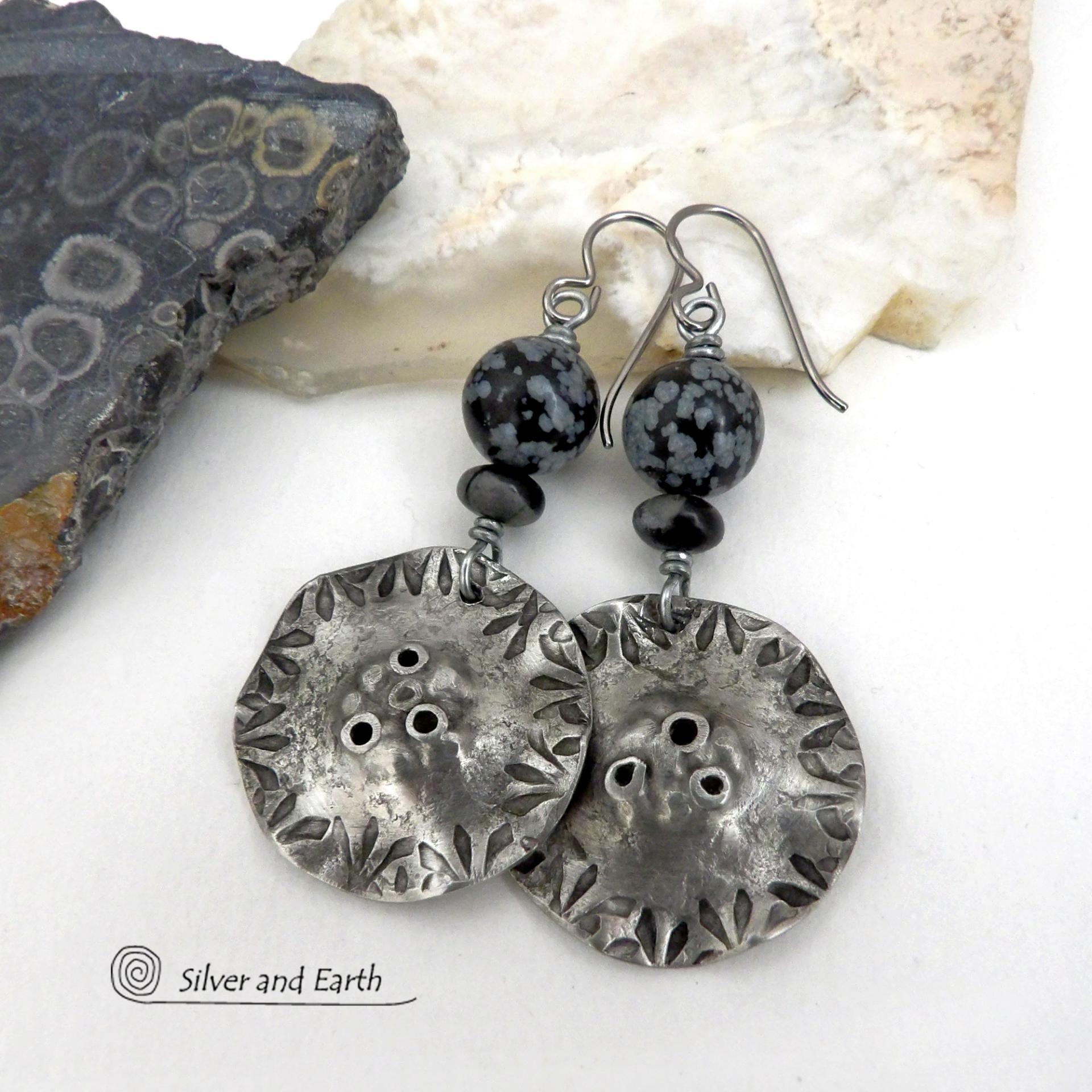 Handcrafted earrings with a modern bold edgy vibe. They feature rustic hammered and hand stamped silver tone pewter dangles accented with natural snowflake obsidian gemstones. The stones have a natural pattern in hues of black and soft gray. This stone is a natural volcanic glass which contains the mineral cristobalite - which creates the "snowflake" type patterns. Bold and striking - they're sure to make a statement. Perfect for women that love natural stones and unique artisan handmade jewelry. 