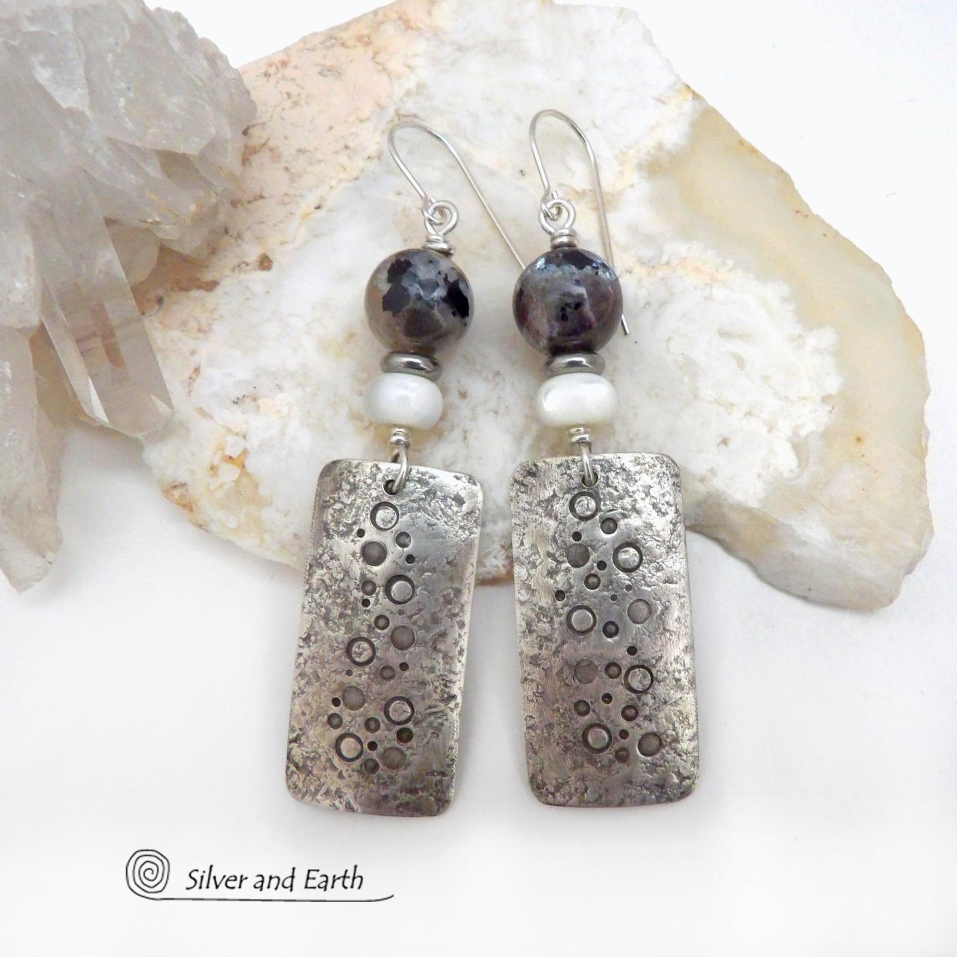 These handcrafted sterling silver earrings have a hand stamped and lightly hammered organic texture and are accented with natural sunstone / moonstone gemstones and mother of pearl and small stainless steel beads. This hybrid stone is rare and found only in Tanzania. It has beautiful shimmery hues of black with natural silvery flashes and subtle peach and gold inclusions. These earrings have a modern, elegant chic style that looks great dressed up or down. Perfect for women that love unique gemstone jewelry