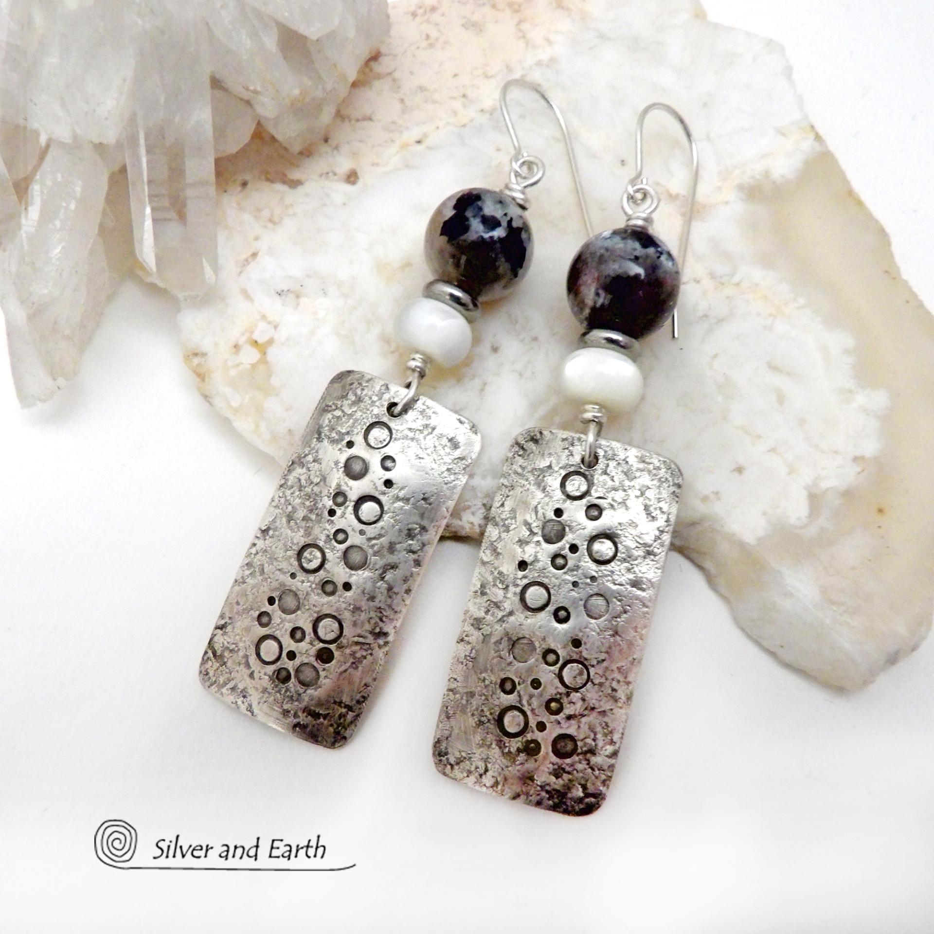 These handcrafted sterling silver earrings have a hand stamped and lightly hammered organic texture and are accented with natural sunstone / moonstone gemstones and mother of pearl and small stainless steel beads. This hybrid stone is rare and found only in Tanzania. It has beautiful shimmery hues of black with natural silvery flashes and subtle peach and gold inclusions. These earrings have a modern, elegant chic style that looks great dressed up or down. Perfect for women that love unique gemstone jewelry