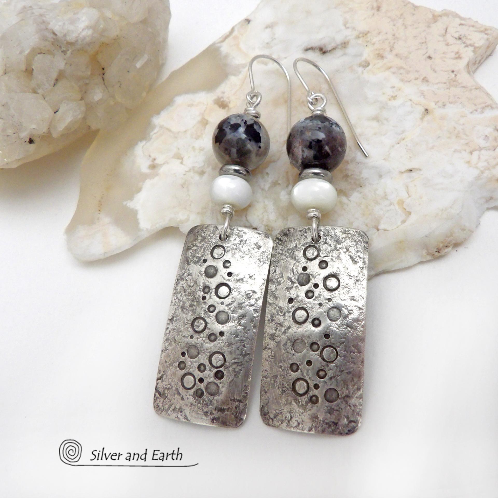 These handcrafted sterling silver earrings have a hand stamped and lightly hammered organic texture and are accented with natural sunstone / moonstone gemstones and mother of pearl and small stainless steel beads. This hybrid stone is rare and found only in Tanzania. It has beautiful shimmery hues of black with natural silvery flashes and subtle peach and gold inclusions. These earrings have a modern, elegant chic style that looks great dressed up or down. Perfect for women that love unique gemstone jewelry