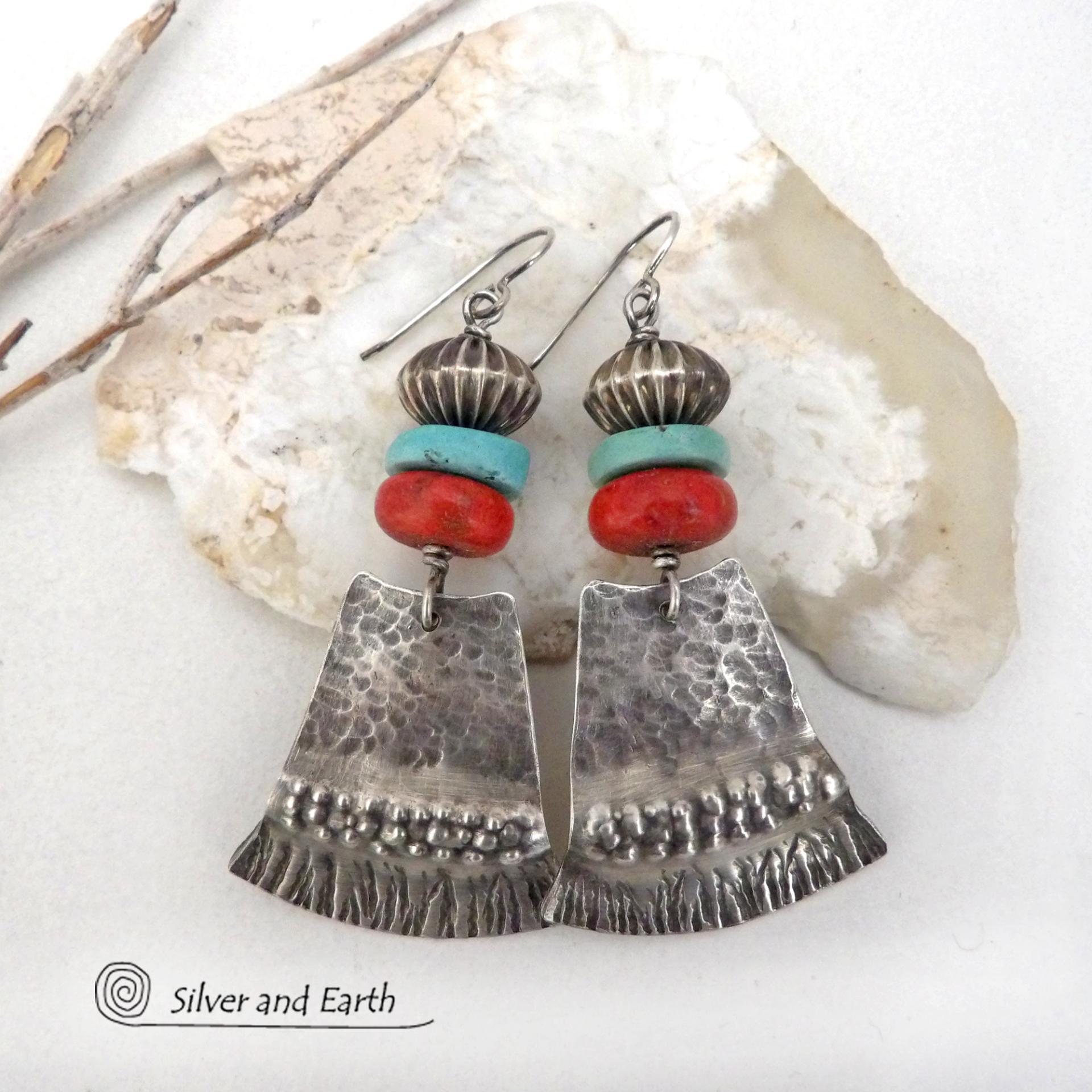 These handcrafted earrings feature hammered and hand stamped sterling silver dangles accented with a stack of natural turquoise stones, fossilized red coral and oxidized sterling silver Native style beads with a rich, corrugated texture. They have a modern, southwestern tribal flair that makes a bold statement. Perfect for women that love the Santa Fe southwest style.The earrings are handmade and are a beautiful example of southwest style jewelry. Handmade by Silver and Earth, a New Mexico True Certified b 