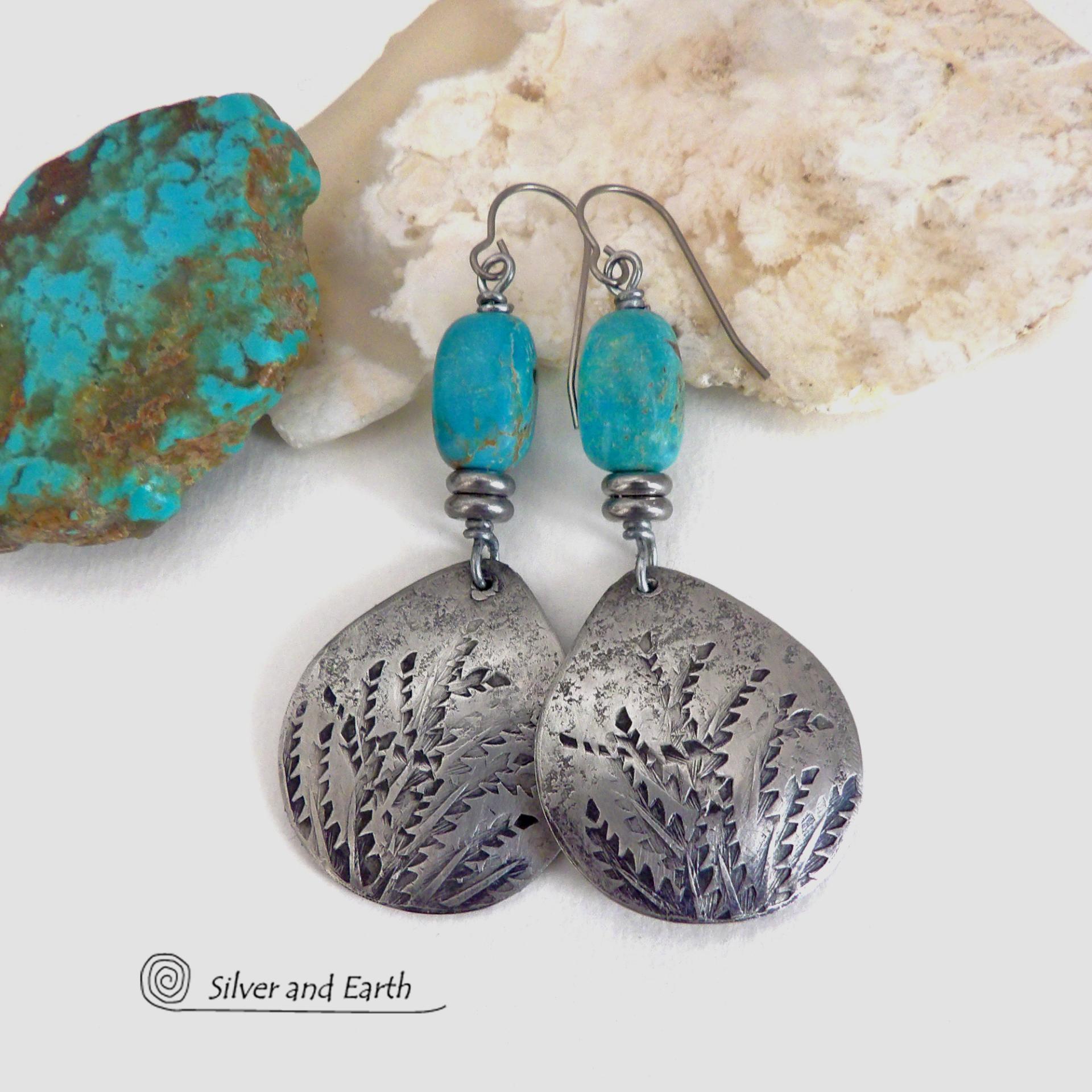 These handcrafted earrings feature silver pewter teardrop-shaped dangles with a hand stamped feather texture accented with natural turquoise stones and small stainless steel beads. They have a modern earthy style with lots of boho chic southwestern flair. They'll make a great gift for anyone that loves natural turquoise stones and southwest style jewelry. Handmade in the USA by Silver and Earth jewelry, a NM True Certfied Business. 