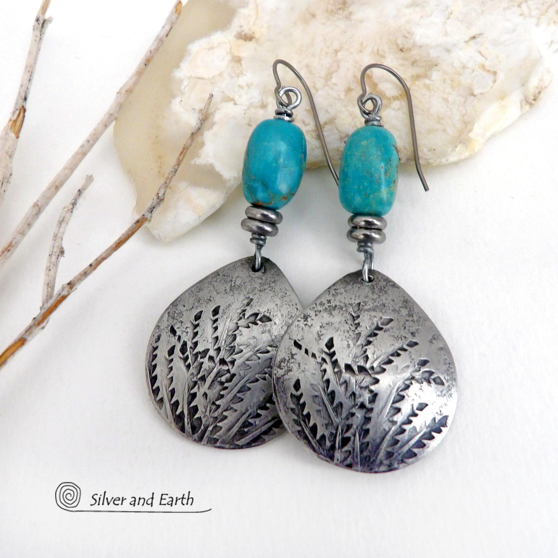 These handcrafted earrings feature silver pewter teardrop-shaped dangles with a hand stamped feather texture accented with natural turquoise stones and small stainless steel beads. They have a modern earthy style with lots of boho chic southwestern flair. They'll make a great gift for anyone that loves natural turquoise stones and southwest style jewelry. Handmade in the USA by Silver and Earth jewelry, a NM True Certfied Business. 