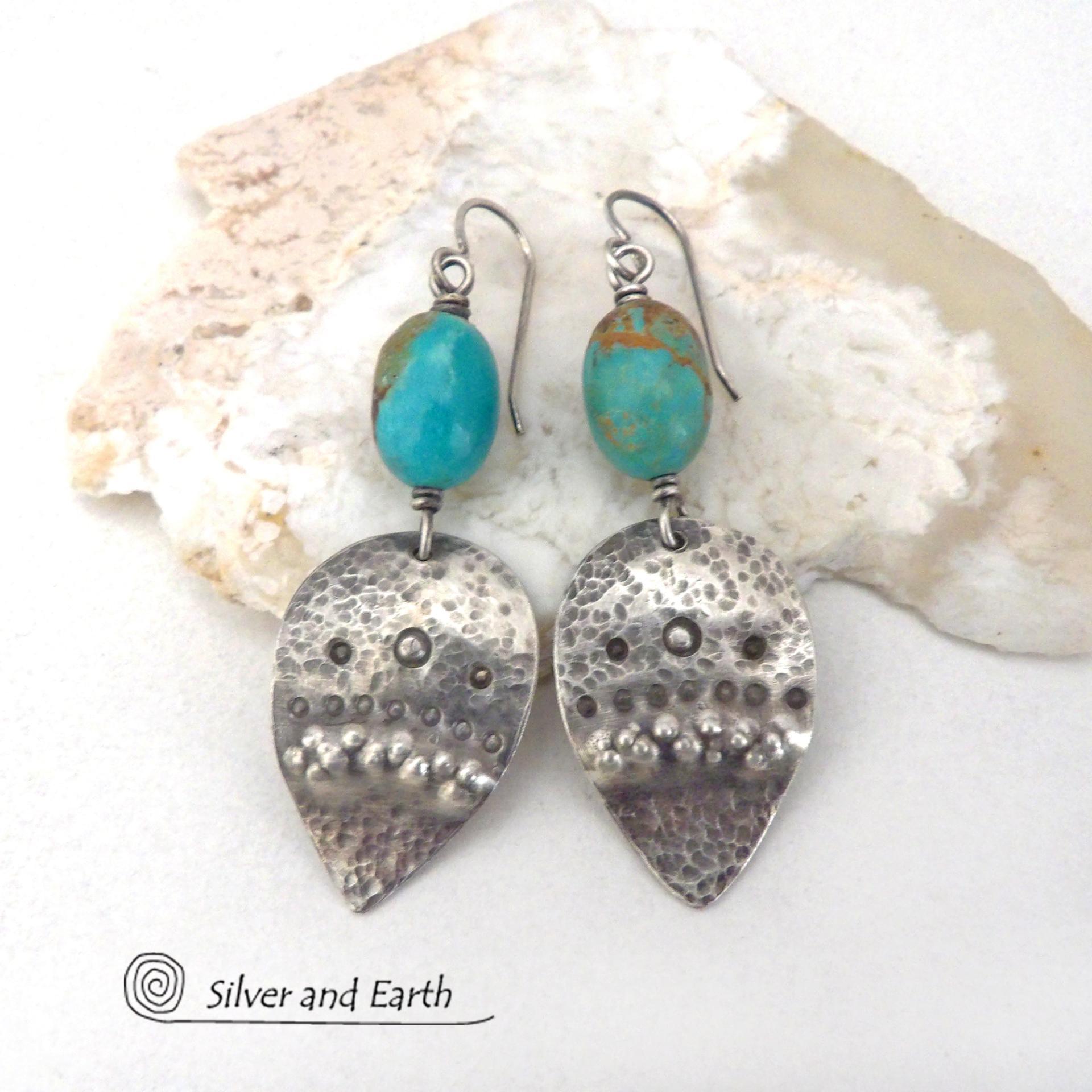 These handcrafted earrings feature natural turquoise nuggets accented with sterling silver dangles with a hammered and hand stamped texture. The stones are a gorgeous shade of turquoise with a natural copper matrix. They have an earthy organic, modern style with southwestern flair. The earrings are handmade and are a beautiful example of southwest style jewelry. Handmade by Silver and Earth, a New Mexico True Certified business.